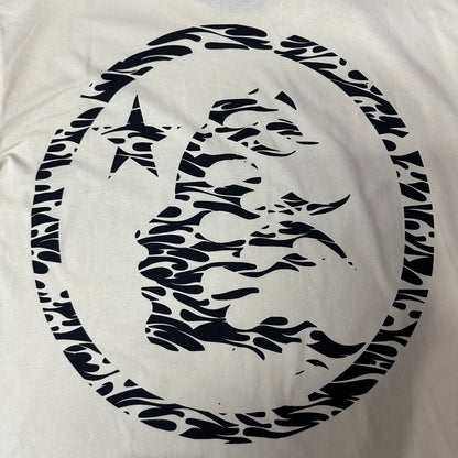 Full oversized flame-face emblem printed on the back of the Hellstar Classic Logo T-Shirt
Large circular Hellstar flame and star emblem on the back of the cream T-shirt
Black flame-profile character graphic on the back of the Hellstar Classic T-Shirt
Close-up of the flame-profile face inside the circular Hellstar back emblem