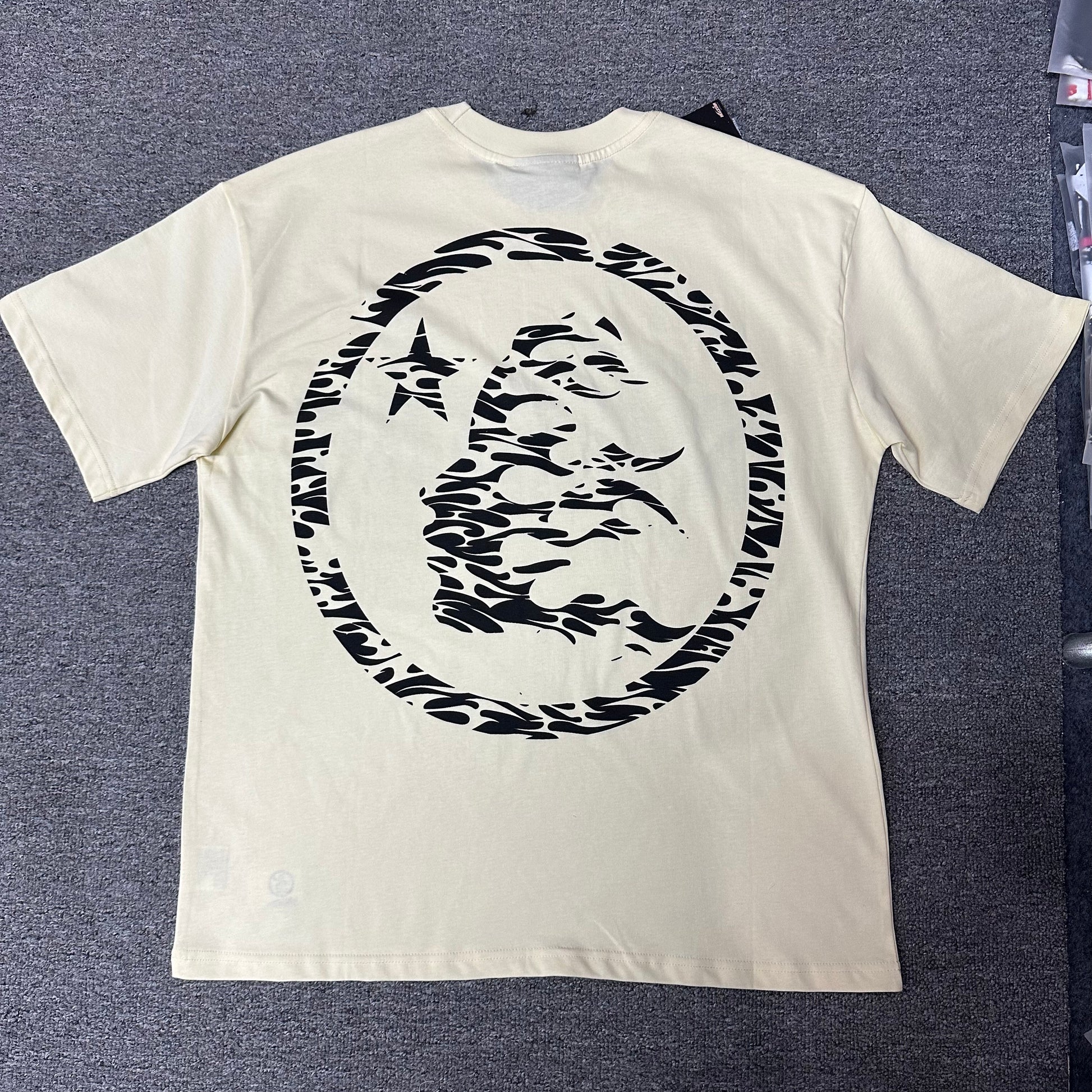 Hellstar Classic Logo cream T-shirt back view with oversized black flame-face emblem