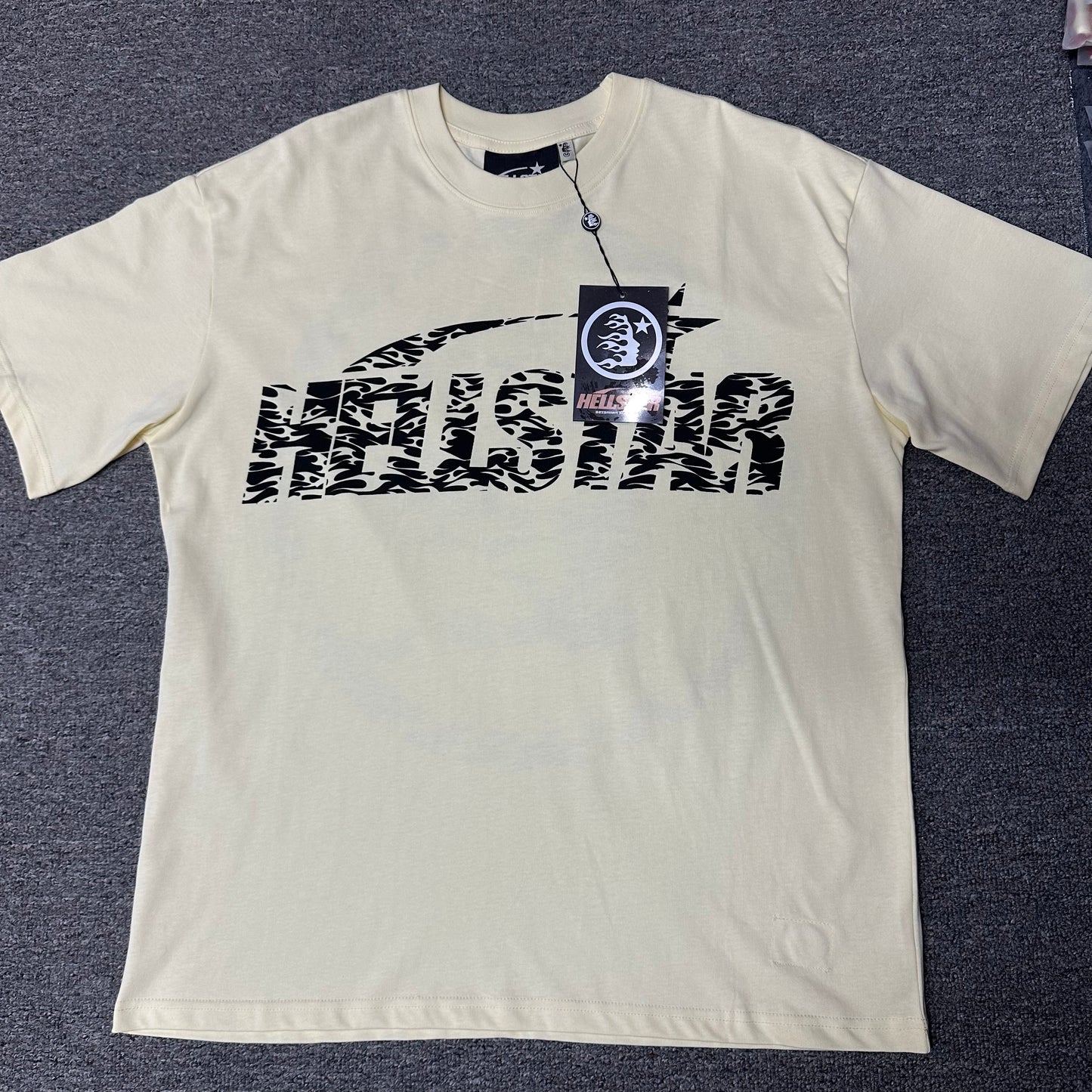 Hellstar Classic Logo Gel Print T-Shirt in cream front view with black flame-pattern wordmark