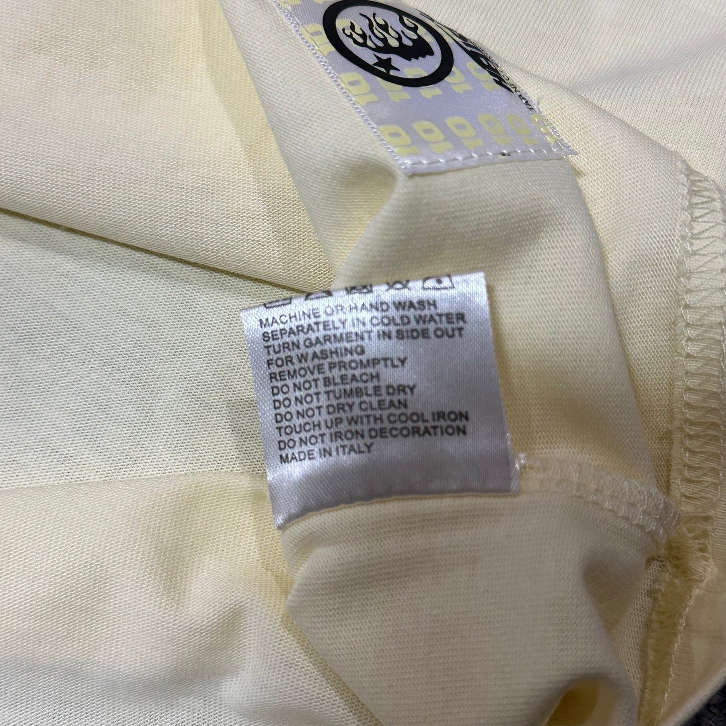 Hellstar Classic Logo T-Shirt wash label showing fabric size and garment care information