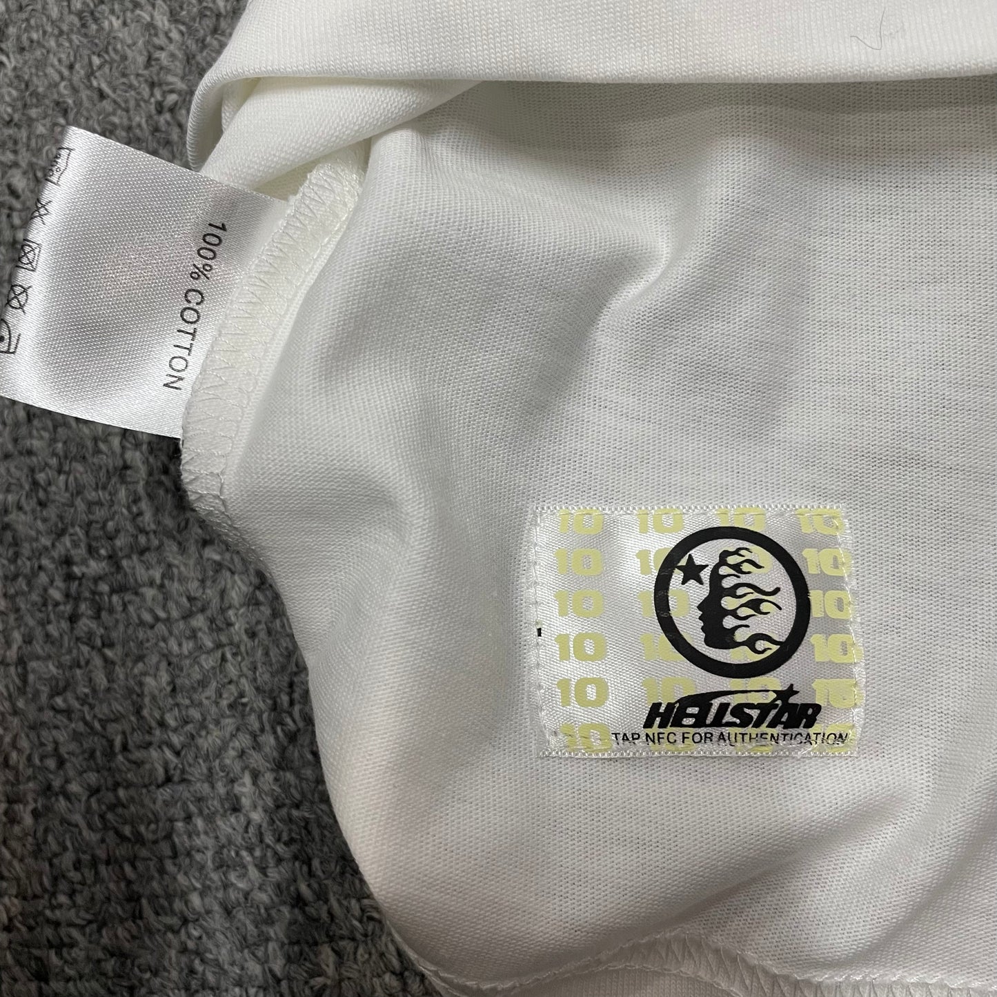 Hellstar French Kiss T-Shirt wash label showing size fabric and garment care information
NFC tag detail on the Hellstar French Kiss T-Shirt for product inspection