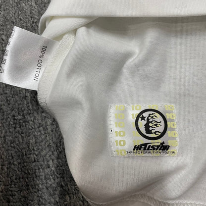 Hellstar French Kiss T-Shirt wash label showing size fabric and garment care information
NFC tag detail on the Hellstar French Kiss T-Shirt for product inspection
