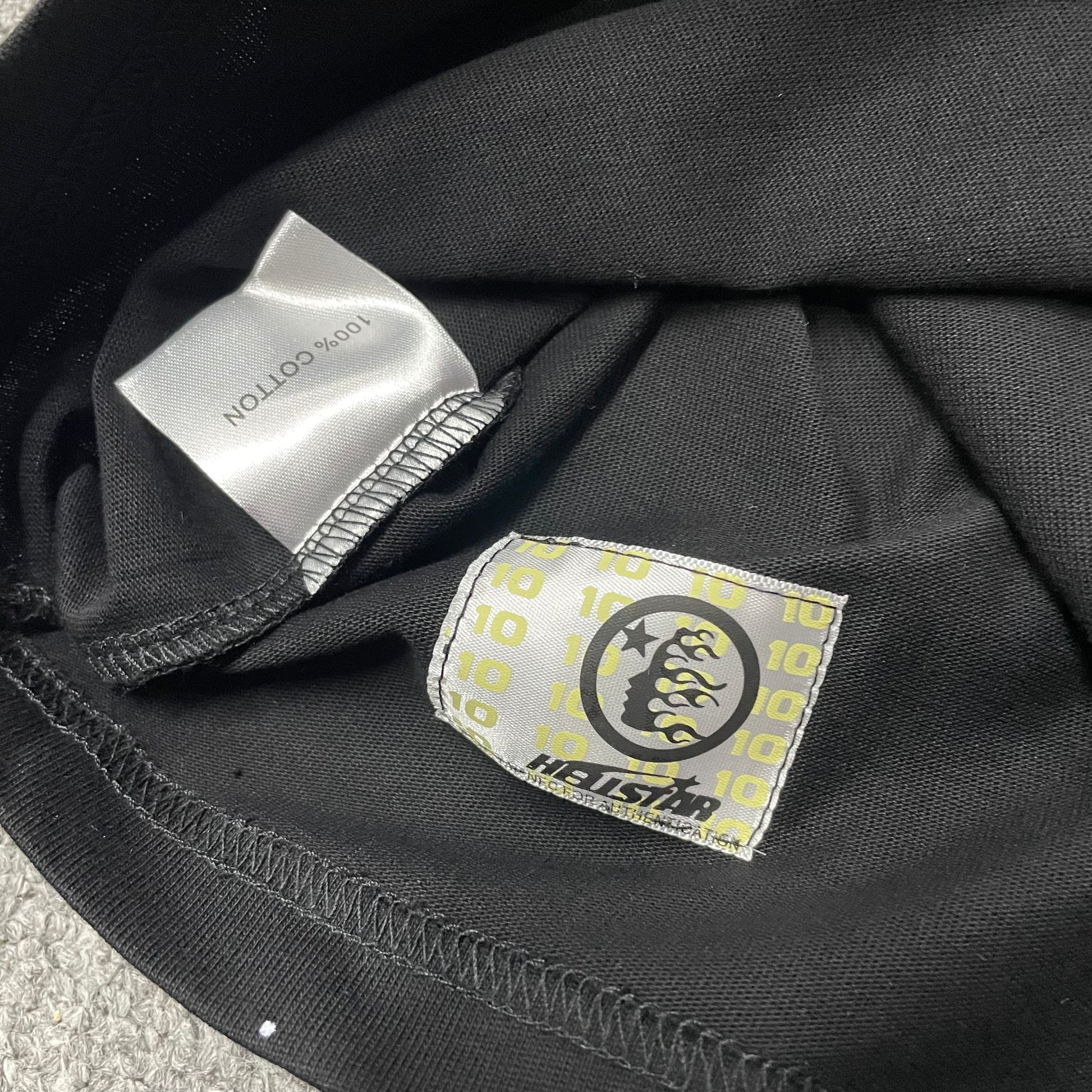 Hellstar The Future T-Shirt wash label showing fabric size and garment care information
NFC tag detail on the Hellstar The Future T-Shirt for product inspection