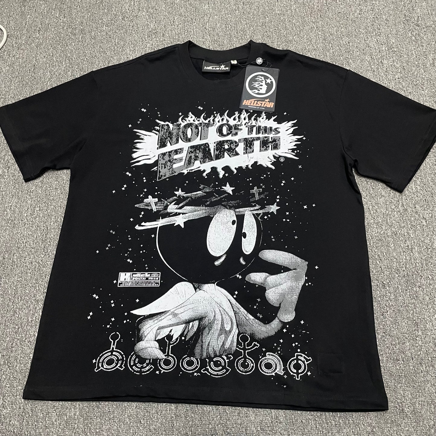 Hellstar Not of This Earth T-Shirt in black front view with oversized monochrome space character graphic