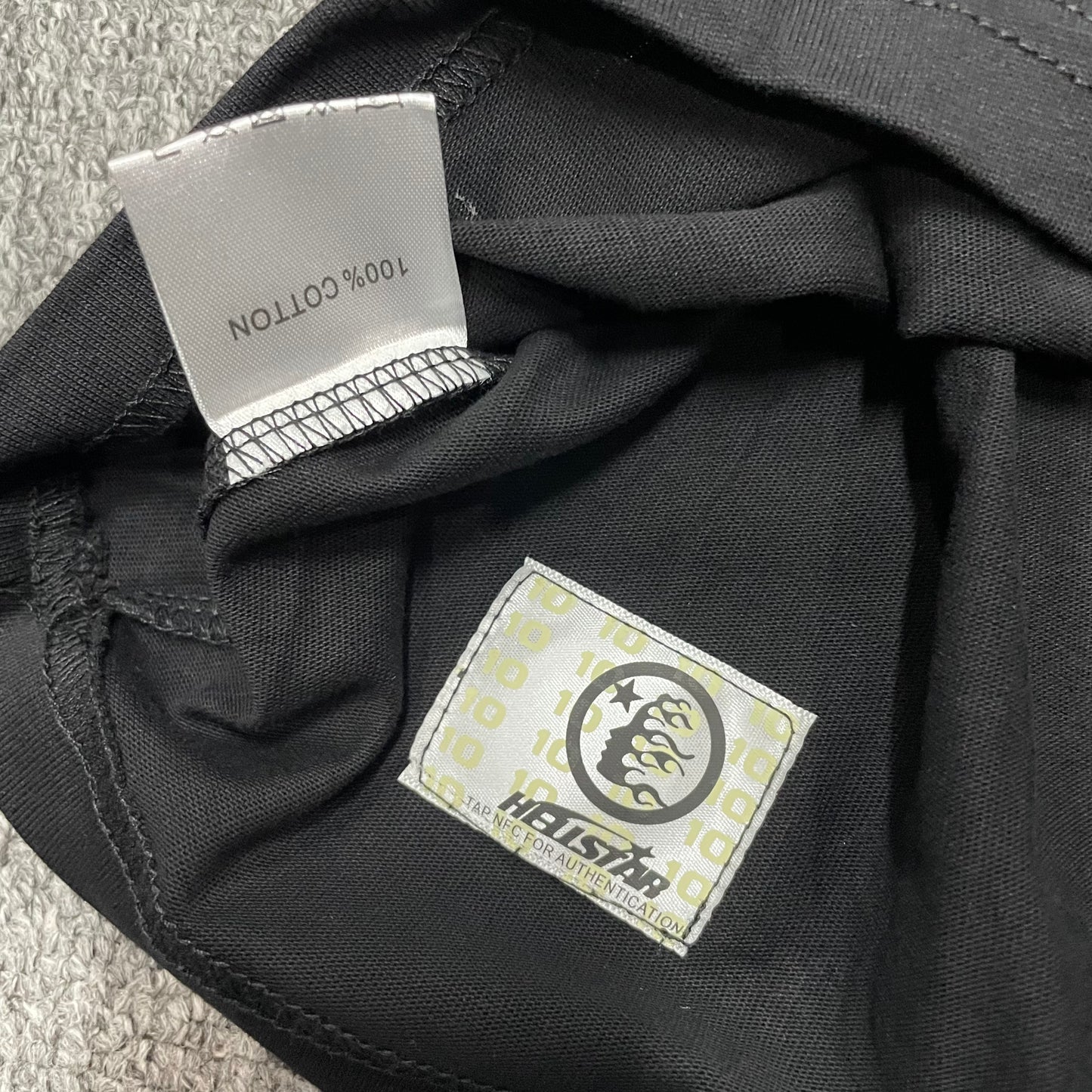 NFC tag detail on the Hellstar Not of This Earth T-Shirt for product inspection
Hellstar Not of This Earth T-Shirt wash label showing fabric size and garment care information