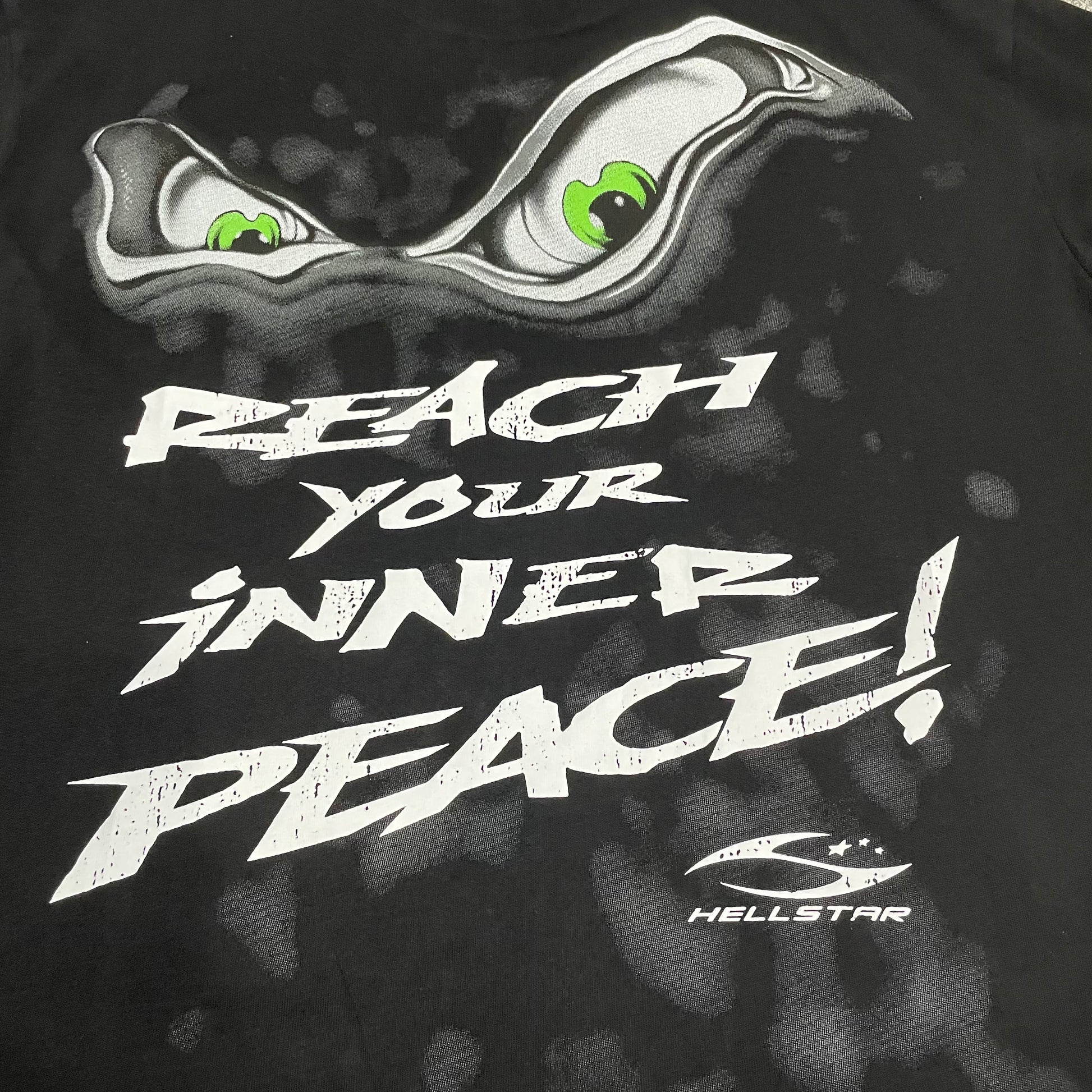 Full rear yoga-inspired graphic artwork on the Hellstar Reach Your Inner Peace Om T-Shirt
Close-up of the back graphic print on the Hellstar Reach Your Inner Peace T-Shirt
Reach Your Inner Peace lettering detail on the back of the Hellstar yoga T-shirt