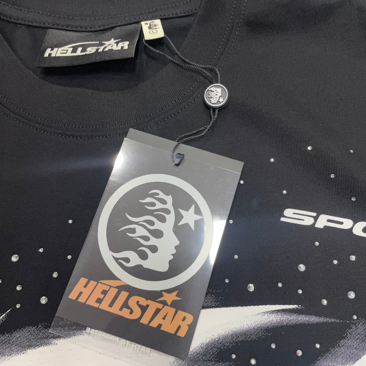 Hellstar branded neck label and crew-neck stitching on the black Blur T-Shirt
Hellstar branded neck label and crew-neck stitching on the black Blur T-Shirt
Black ribbed crew-neck collar and stitching detail on the Hellstar Blur graphic T-shirt
Hellstar branded hangtag attached to the black Blur graphic T-shirt
