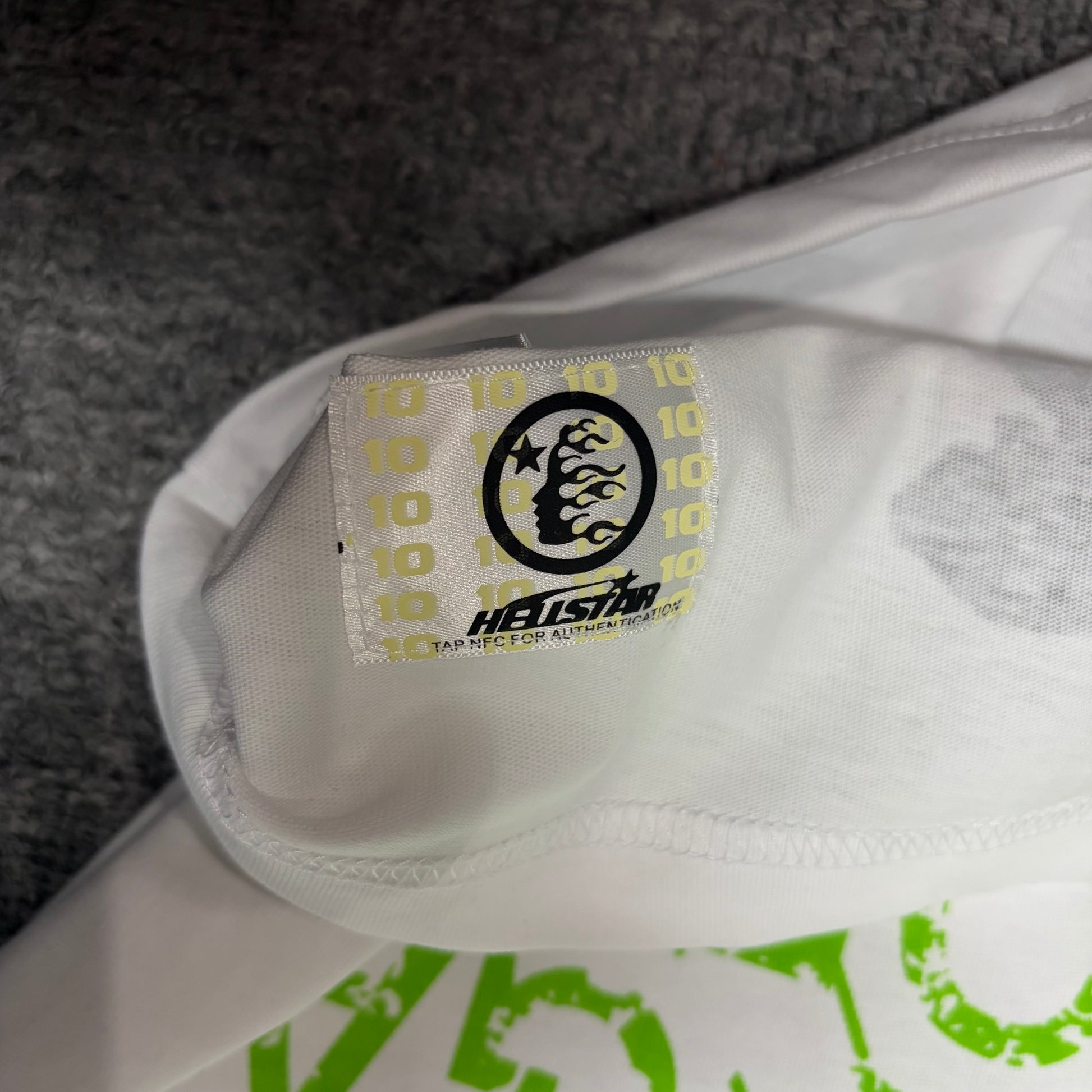 NFC tag detail on the Hellstar Reach Your Inner Peace T-Shirt for product inspection