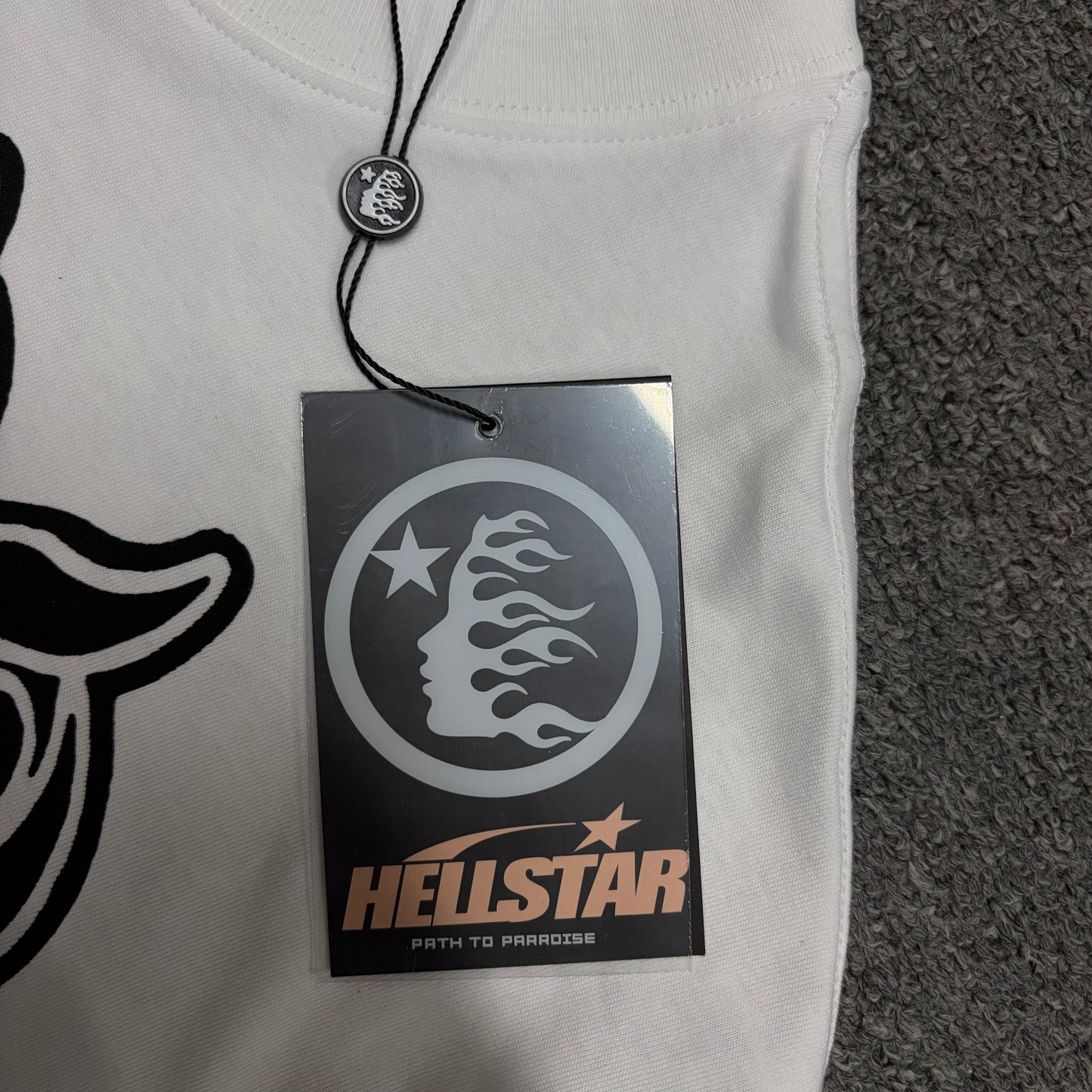 Front view of the Hellstar flame and star logo hangtag
