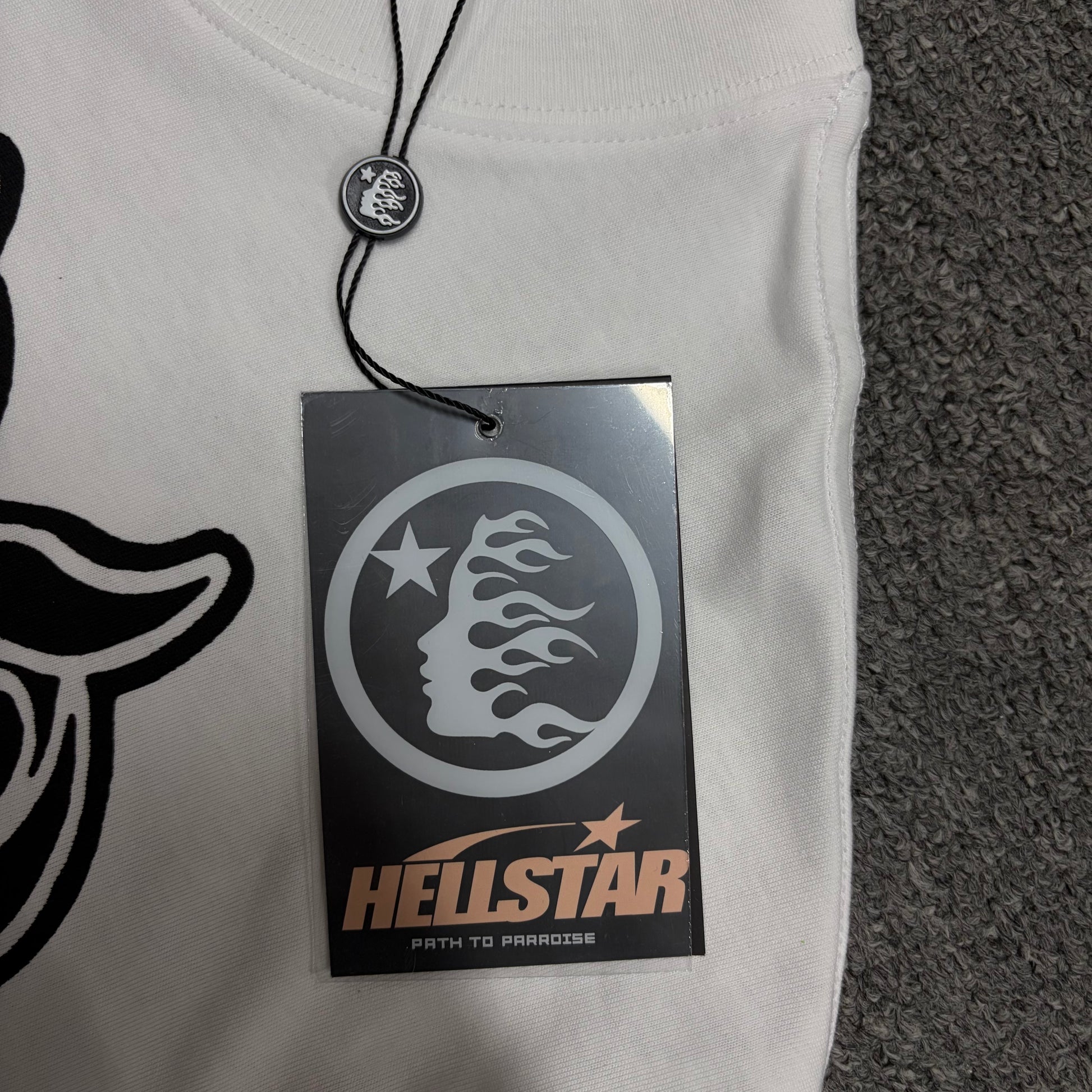 Front view of the Hellstar flame and star logo hangtag