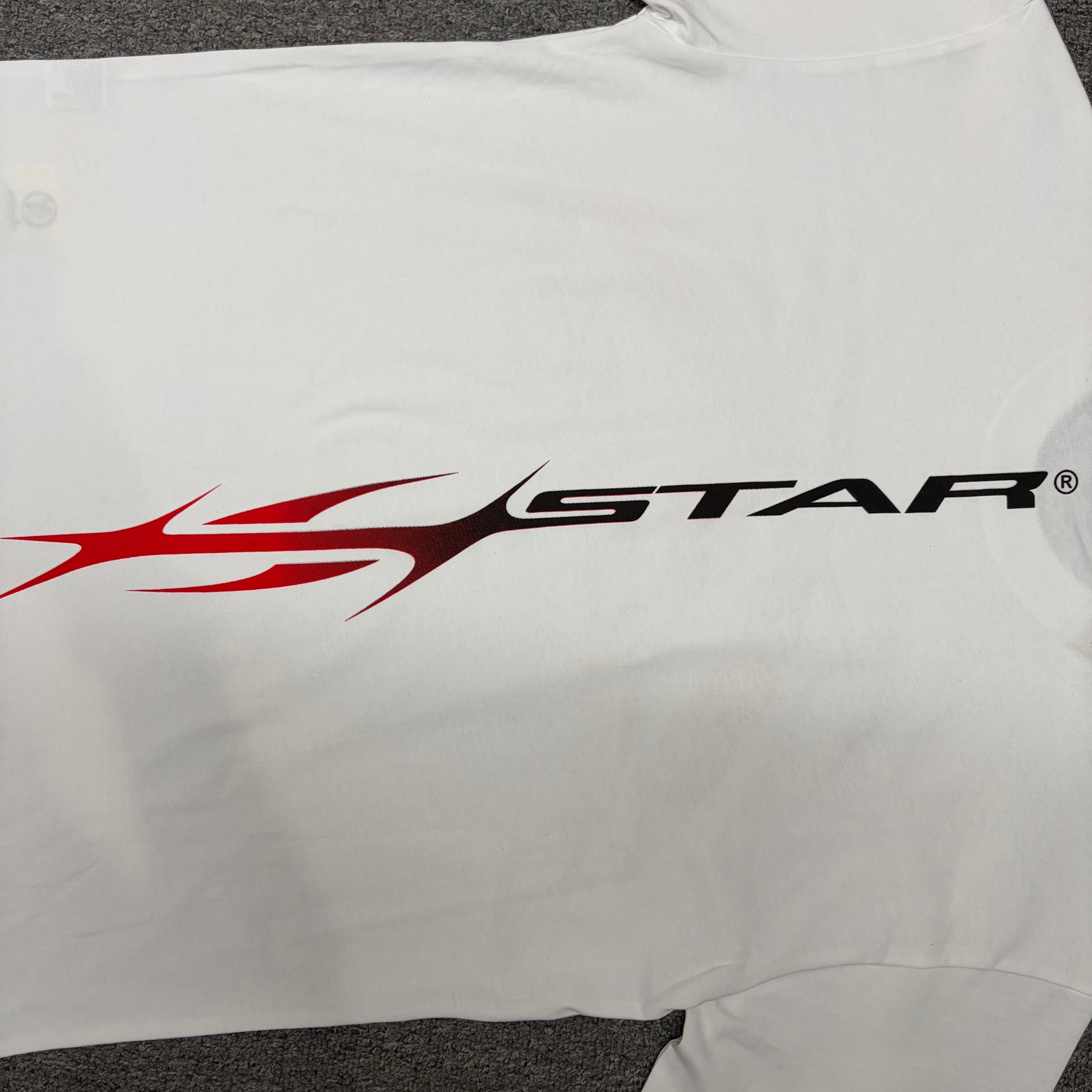 Full back graphic artwork on the white Hellstar Gradient Flame Sports Logo T-Shirt
Hellstar Sports logo graphic printed across the back of the white T-shirt