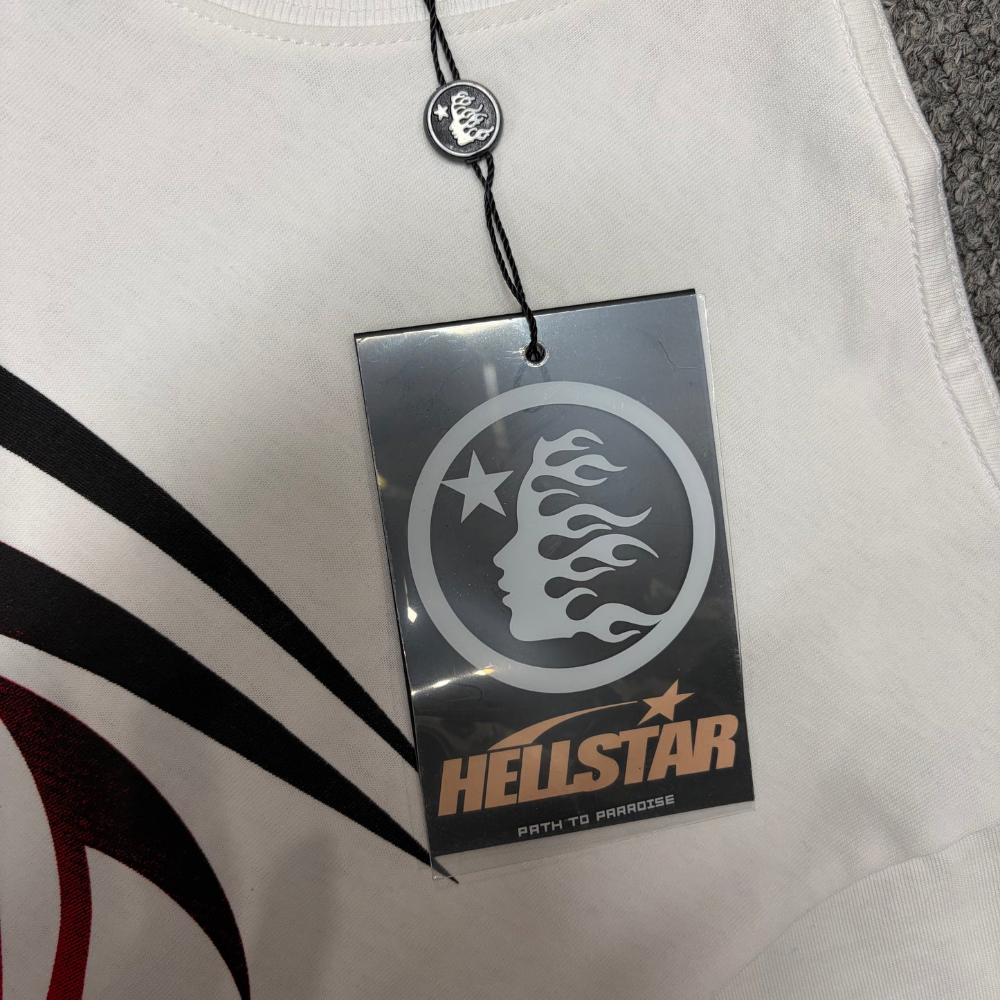 Hellstar branded hangtag attached to the Gradient Flame Sports Logo T-Shirt