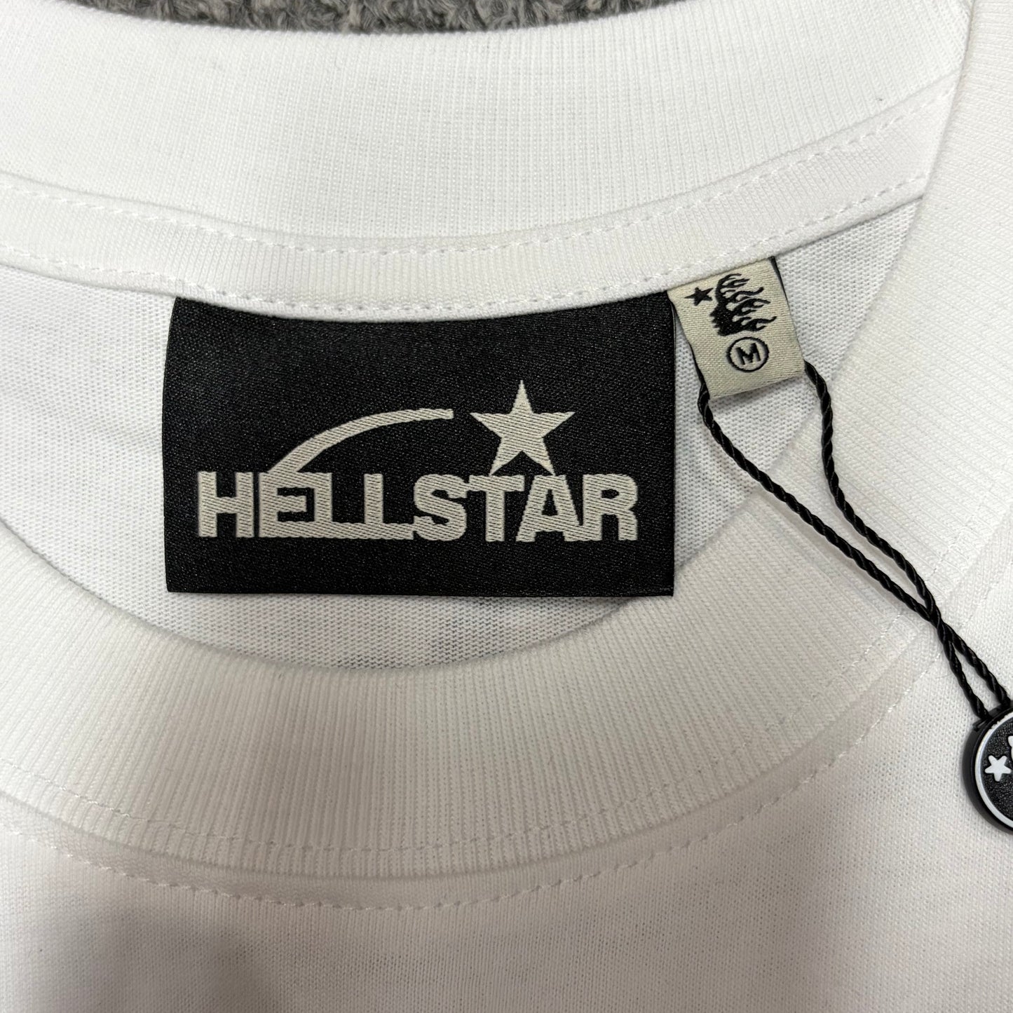 Hellstar branded neck label inside the Gradient Flame Sports Logo T-Shirt
White ribbed crew-neck collar and stitching detail on the Hellstar T-Shirt
Size label detail inside the Hellstar Gradient Flame Sports Logo T-Shirt