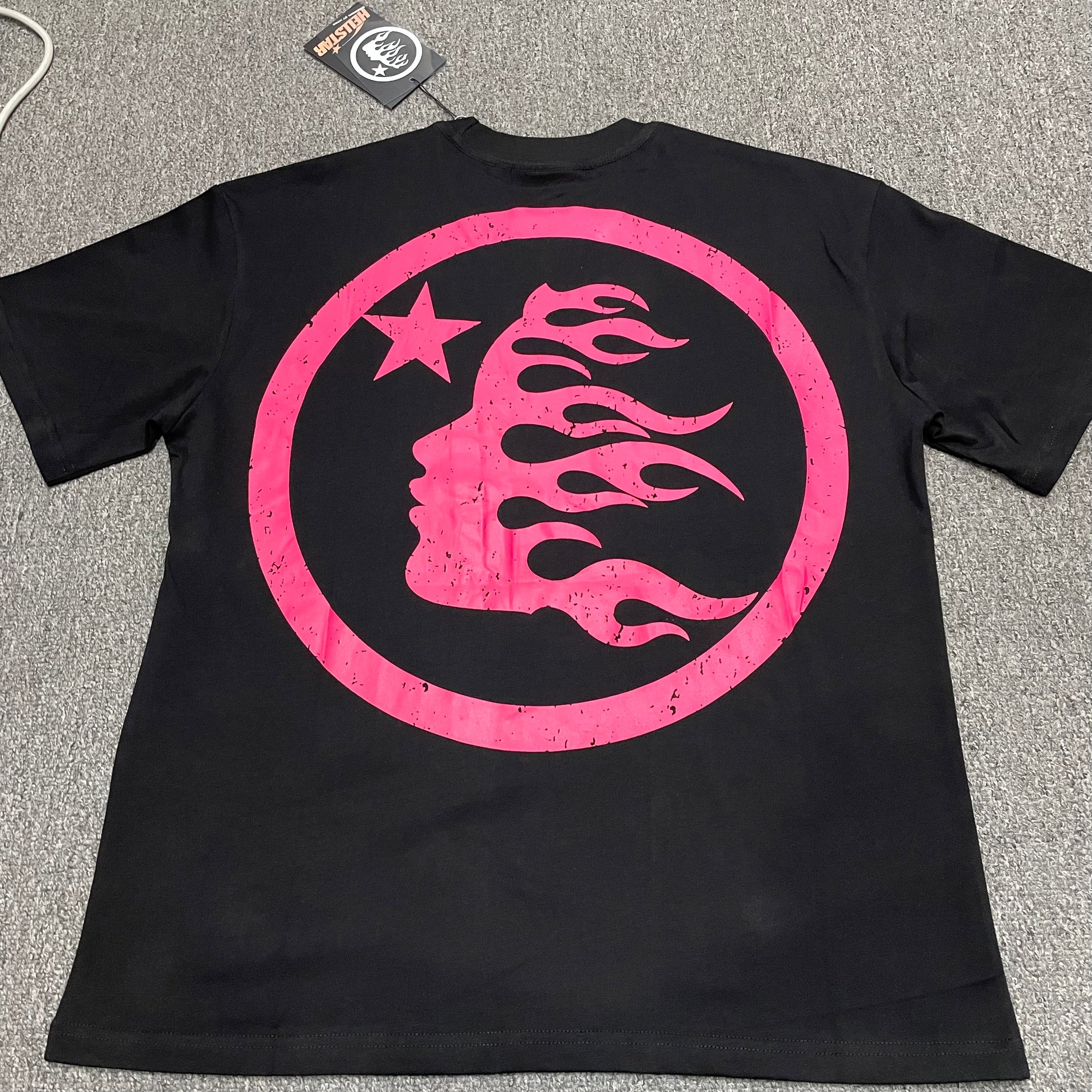 Hellstar Adventure Astronaut black T-shirt back view with oversized pink flame-face emblem