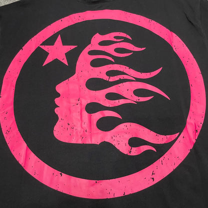 Full oversized pink circular graphic printed on the back of the Hellstar Adventure T-Shirt
Pink flame-profile character inside the circular back graphic on the Hellstar T-Shirt
White star detail inside the oversized pink Hellstar back graphic