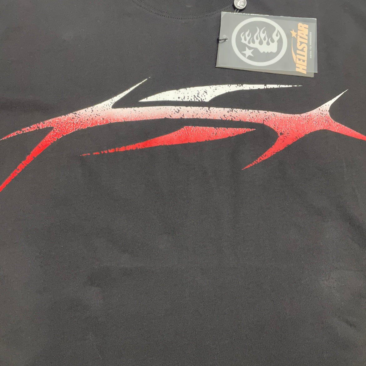 Full red and white gradient sports graphic printed across the front of the black Hellstar T-Shirt
Sharp motion-inspired Hellstar sports logo with red and white gradient artwork
Distressed print effect inside the Hellstar red gradient sports graphic