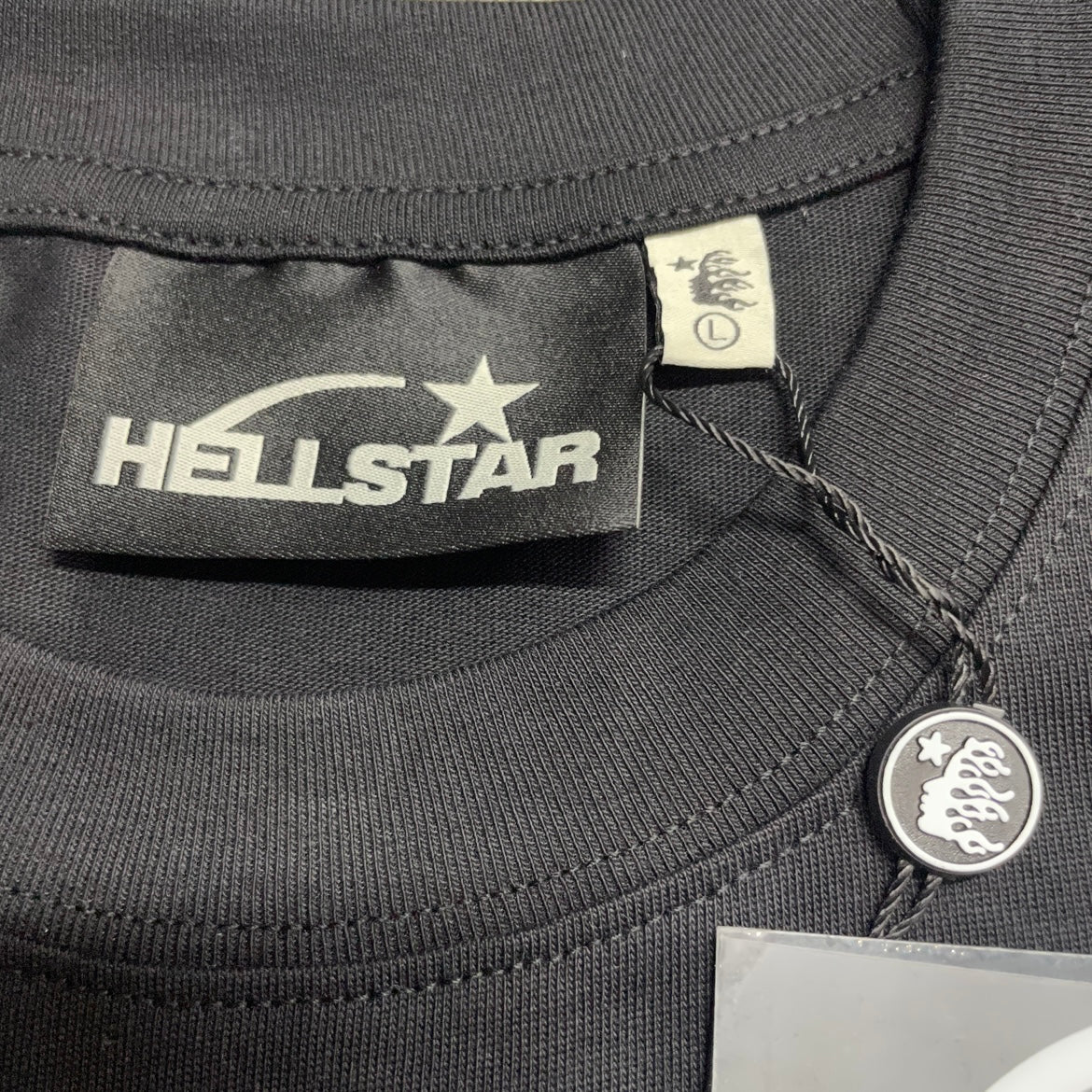 Hellstar branded neck label inside the Red Gradient Sports Logo T-Shirt
Black ribbed crew-neck collar and stitching detail on the Hellstar T-Shirt
Size label detail inside the black Hellstar Sports Logo T-Shirt