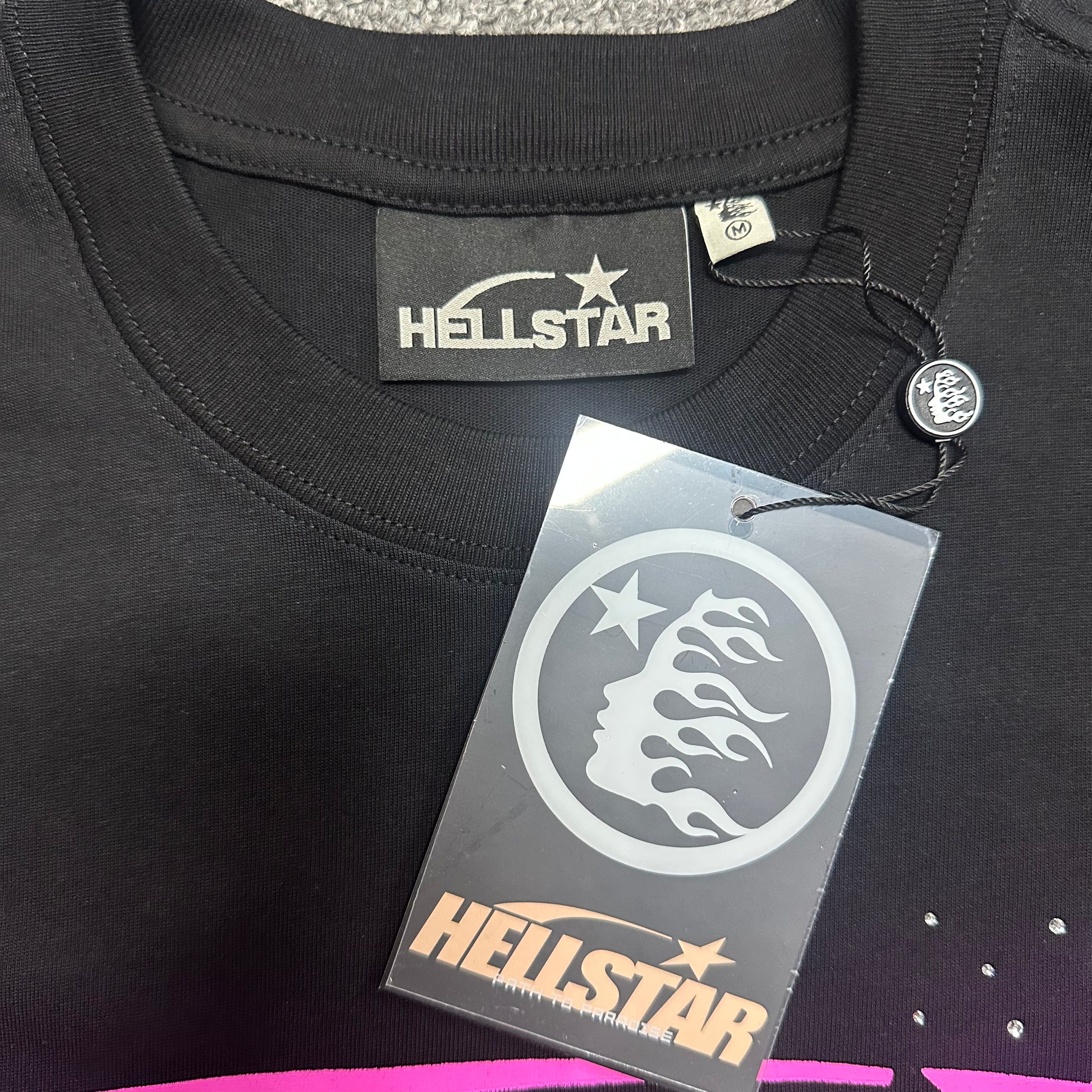 Hellstar branded neck label inside the black Classic Rhinestone Logo T-Shirt
Hellstar branded hangtag attached to the Classic Rhinestone Logo T-Shirt