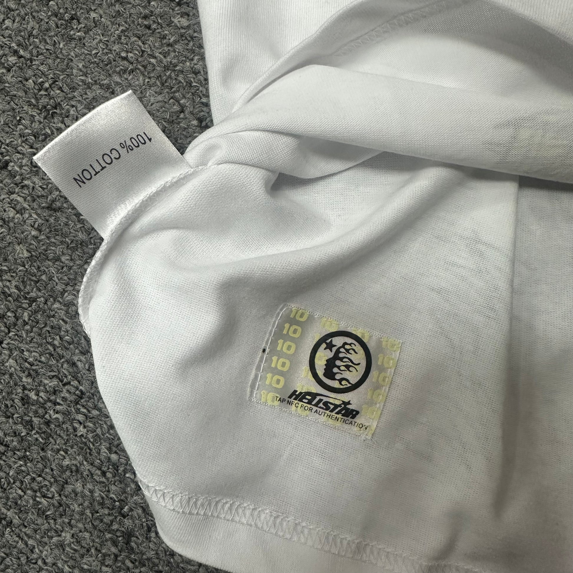 Hellstar wash care label and garment information inside the Paradise Lambs T-shirt
NFC tag detail on the Hellstar Paradise Lambs white graphic T-shirt