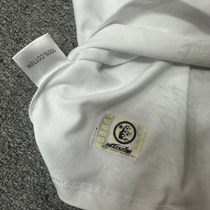 Hellstar wash care label and garment information inside the Paradise Lambs T-shirt
NFC tag detail on the Hellstar Paradise Lambs white graphic T-shirt