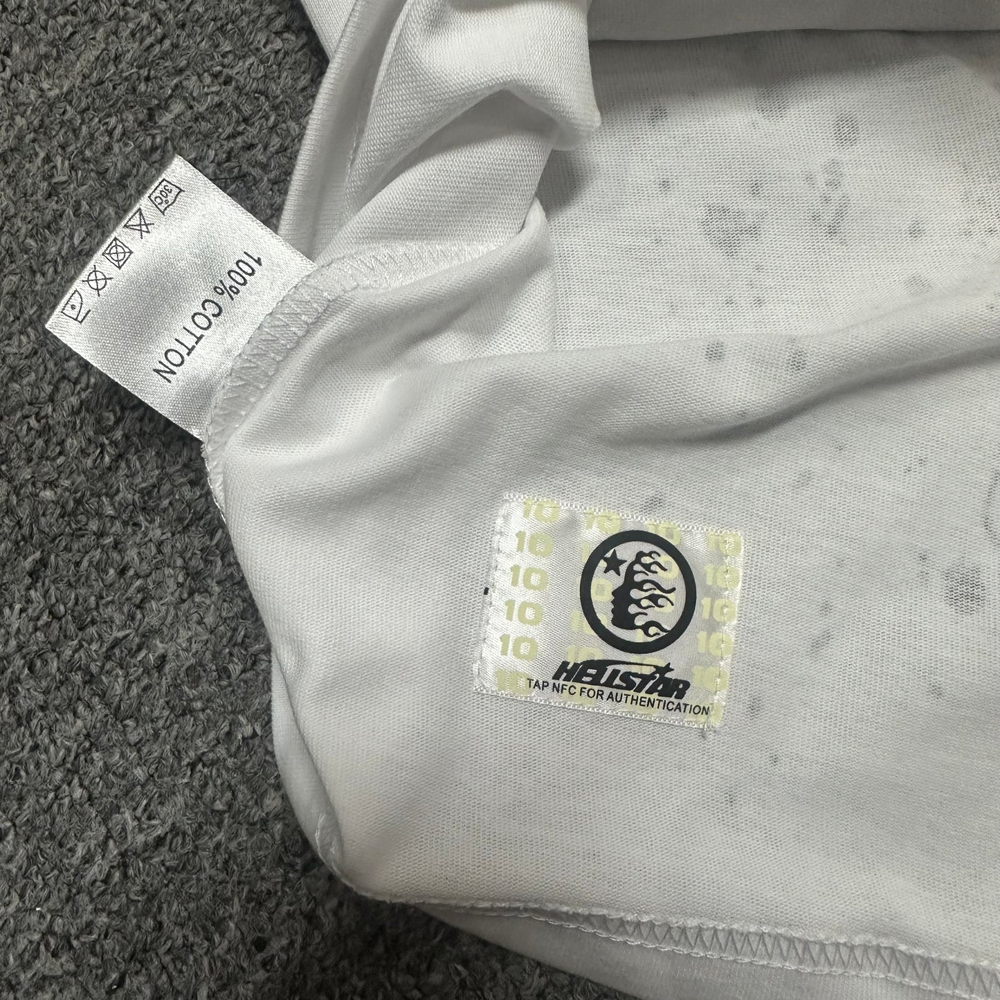 Hellstar wash care label and garment information inside the Online T-shirt
NFC tag detail on the Hellstar Online white graphic T-shirt