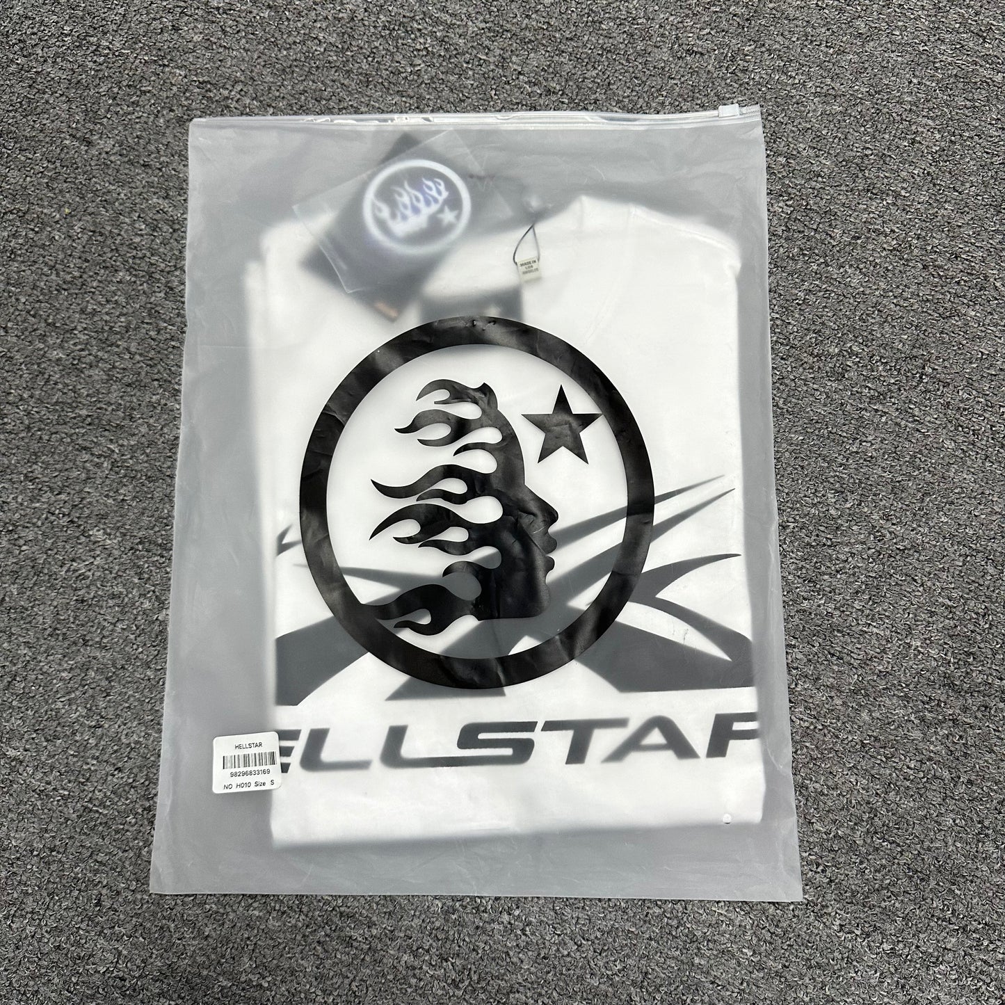 Hellstar Classic white T-shirt folded inside an individual zip packaging bag
Wholesale-ready Hellstar Classic T-shirt with labels hangtag and packaging