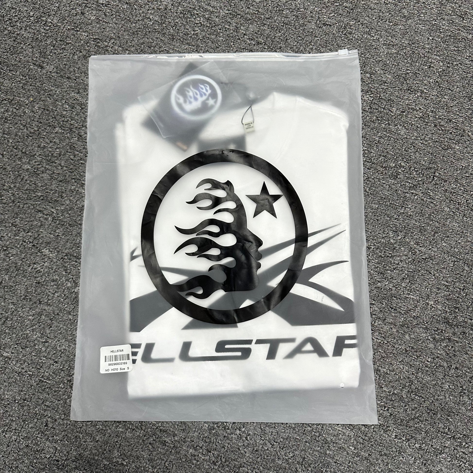 Hellstar Classic white T-shirt folded inside an individual zip packaging bag
Wholesale-ready Hellstar Classic T-shirt with labels hangtag and packaging