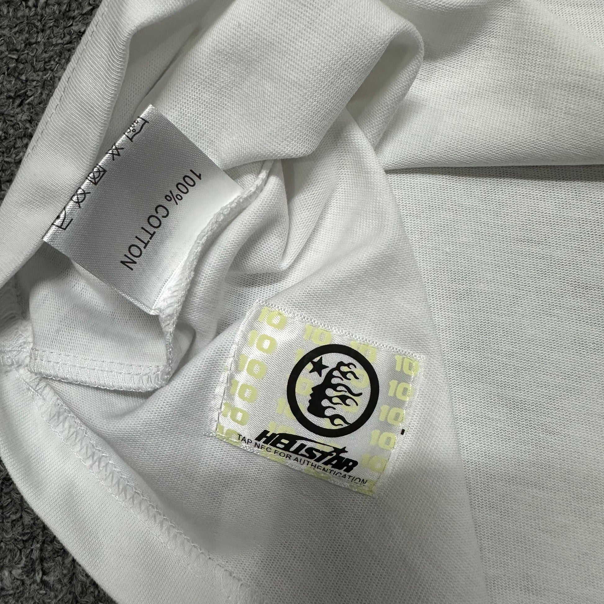 Hellstar wash care label inside Classic Logo white T-shirt
NFC tag detail attached to Hellstar Classic white T-shirt
