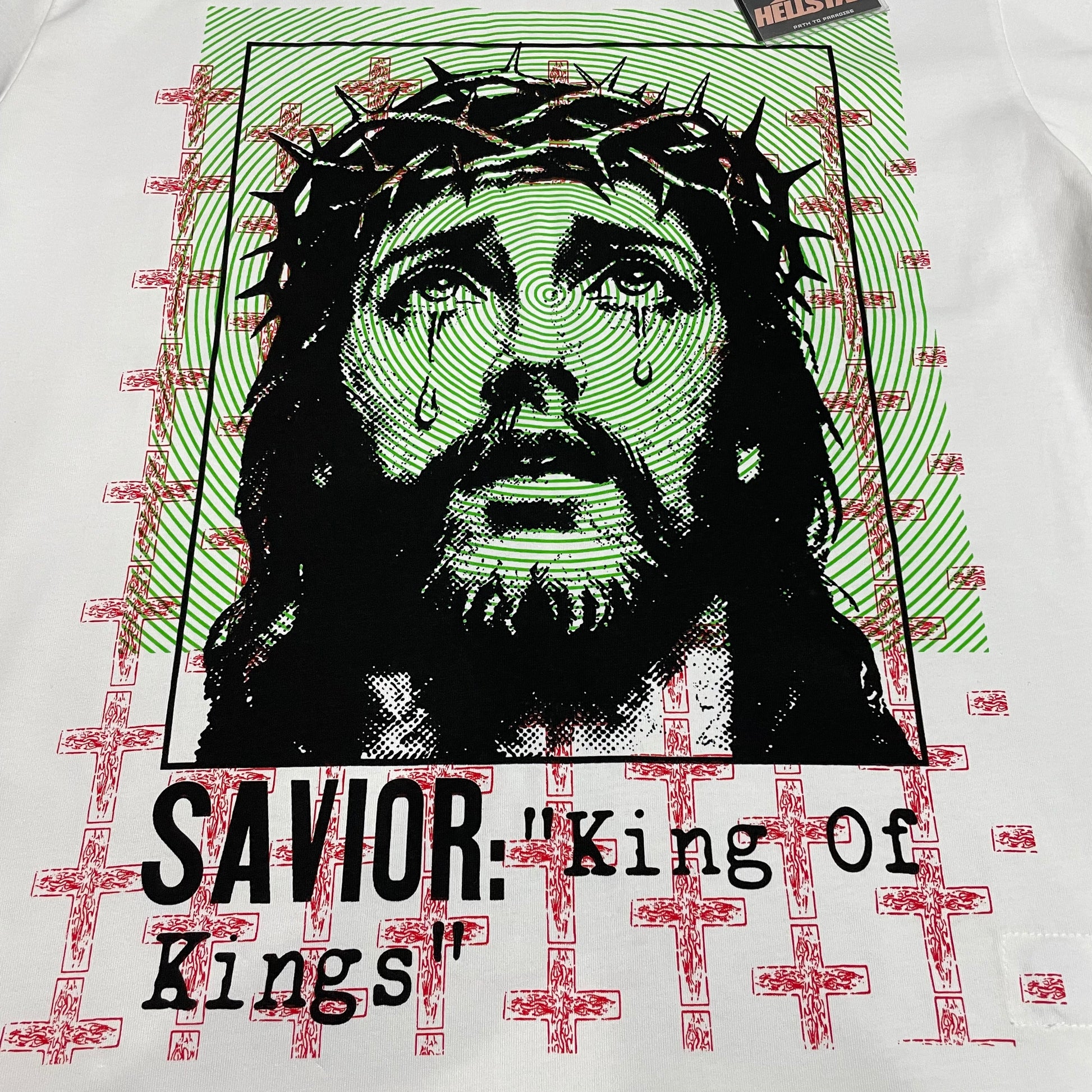 Full Savior King of Kings portrait graphic on Hellstar Jesus white T-shirt
Close-up of the crown-of-thorns portrait on Hellstar Jesus graphic T-shirt
Savior portrait graphic detail on Hellstar Jesus King of Kings T-shirt
Crown-of-thorns artwork detail on Hellstar Jesus white graphic T-shirt
Green spiral background print detail on Hellstar Jesus T-shirt
