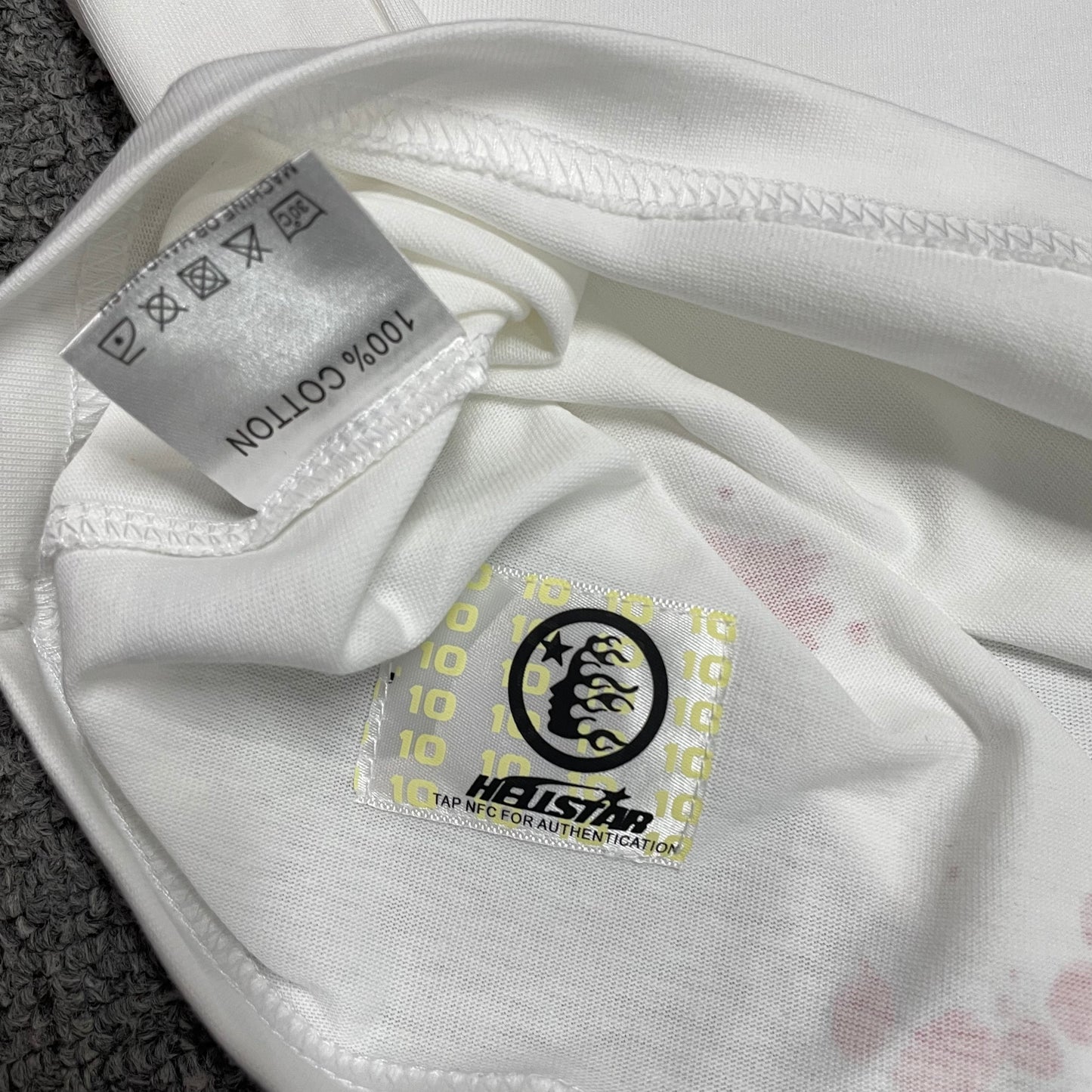 Hellstar wash care label inside H Star graphic T-shirt
Close-up of the NFC tag on Hellstar H Star graphic T-shirt