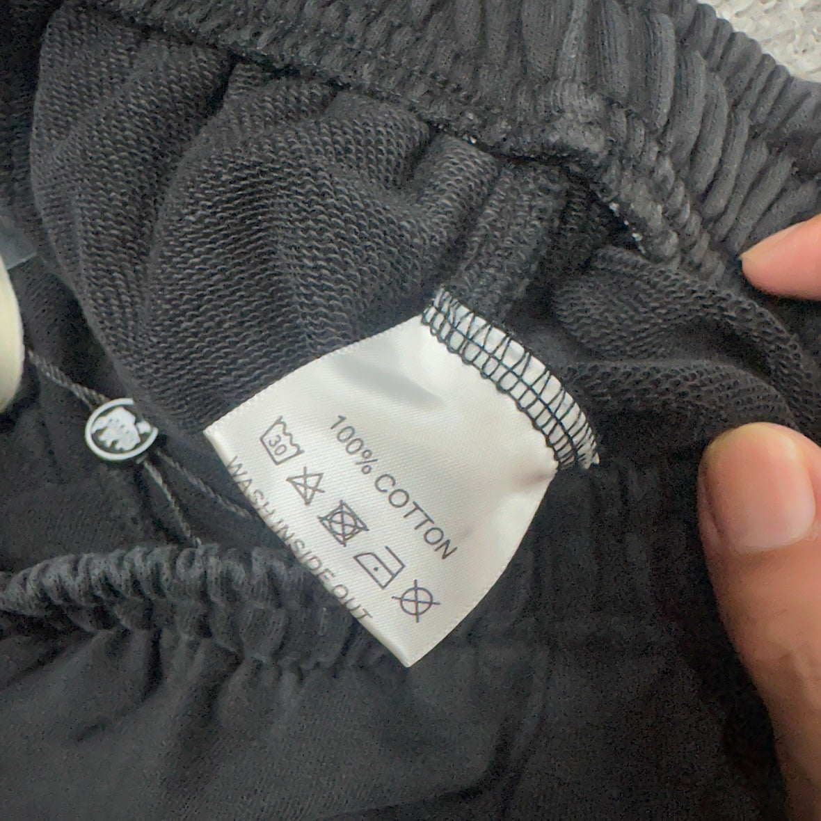 Fabric composition and care label inside Hellstar graphic shorts
Close-up of reinforced crotch seam on Hellstar black shorts