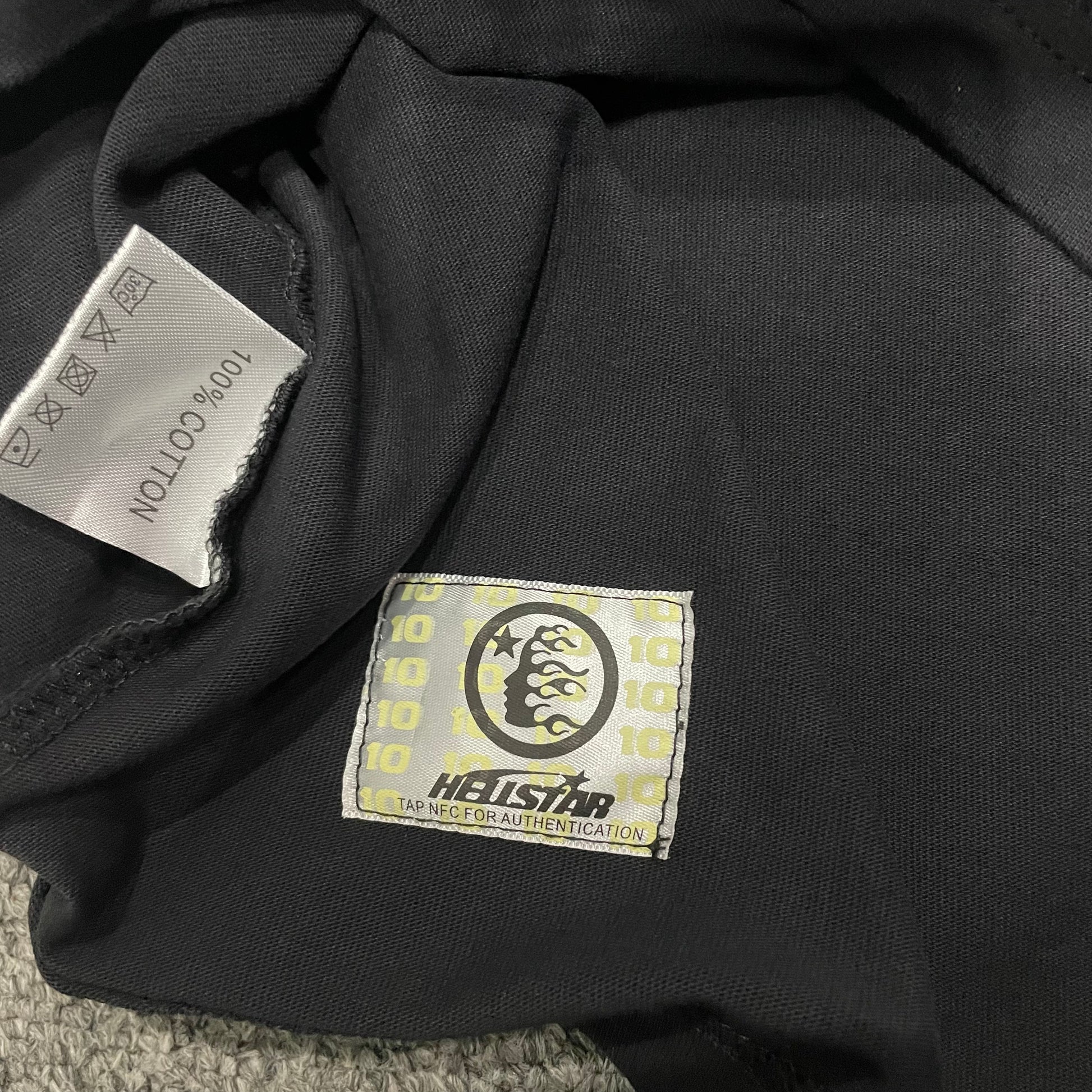 Hellstar wash care label inside Chrome Logo graphic T-shirt
NFC tag detail attached to Hellstar Chrome Logo black T-shirt