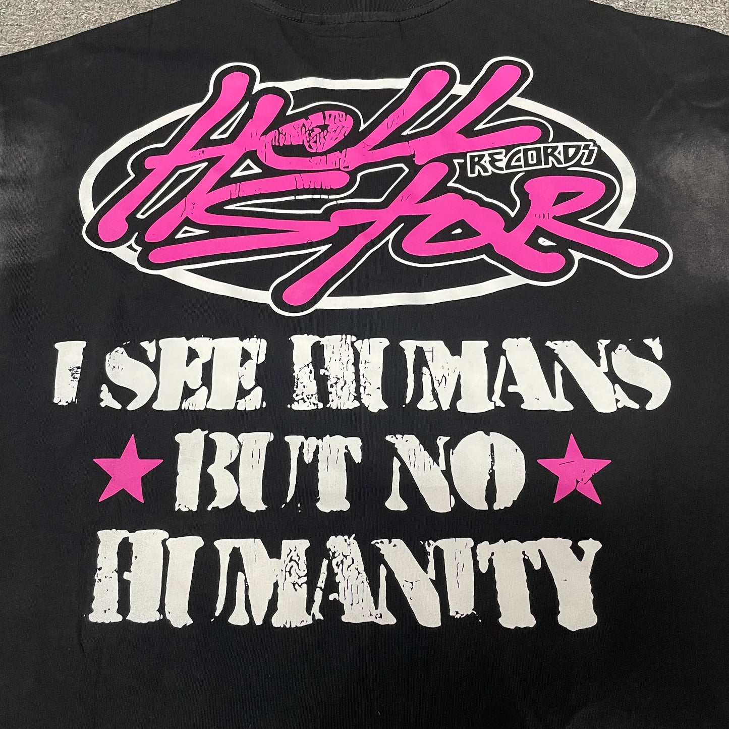 Pink and white high-contrast print detail on Hellstar washed black T-shirt
Full back graphic on Hellstar I See Humans But No Humanity T-shirt
Close-up of the rear artwork on Hellstar No Humanity graphic T-shirt
