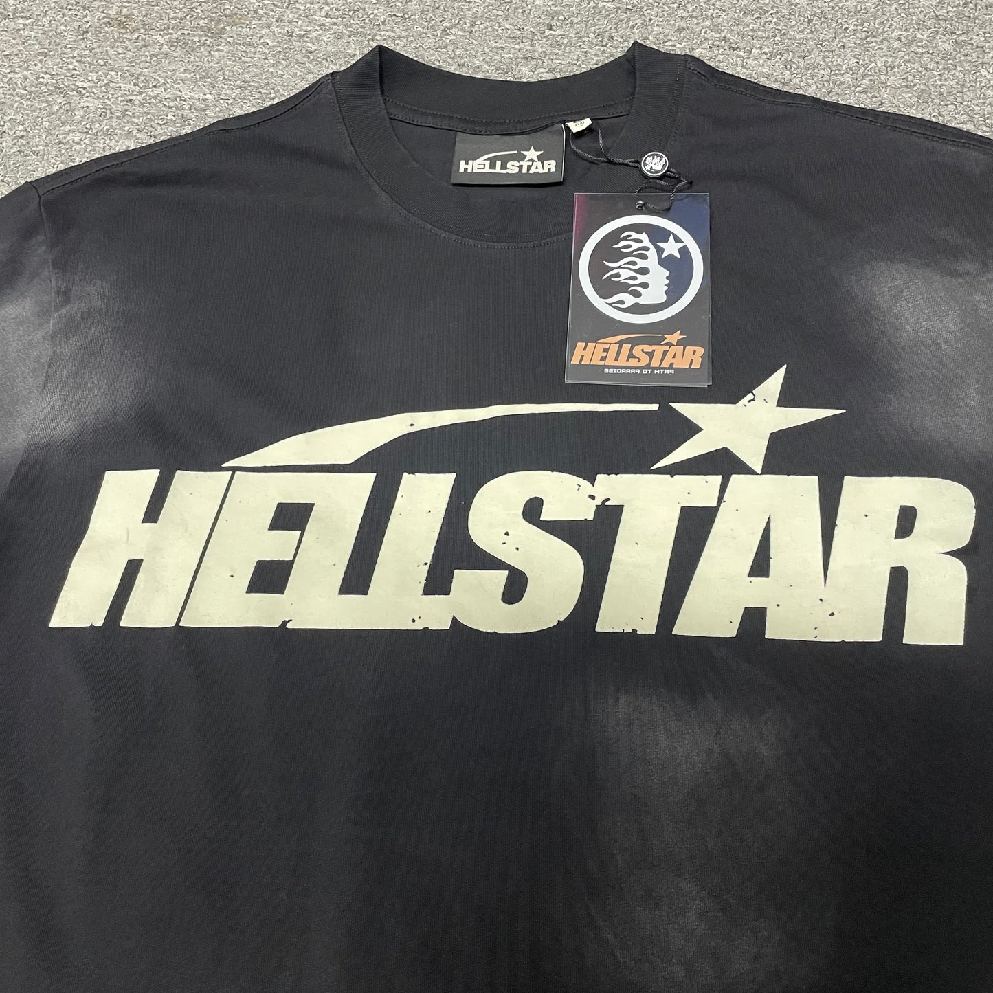 Full cream Hellstar Classic logo graphic on washed black T-shirt
Close-up of the cream Hellstar Classic logo on black T-shirt
Detailed cream logo print on Hellstar Classic washed black T-shirt
Oversized Hellstar lettering across the Classic black T-shirt
Hellstar shooting-star graphic above the cream logo lettering