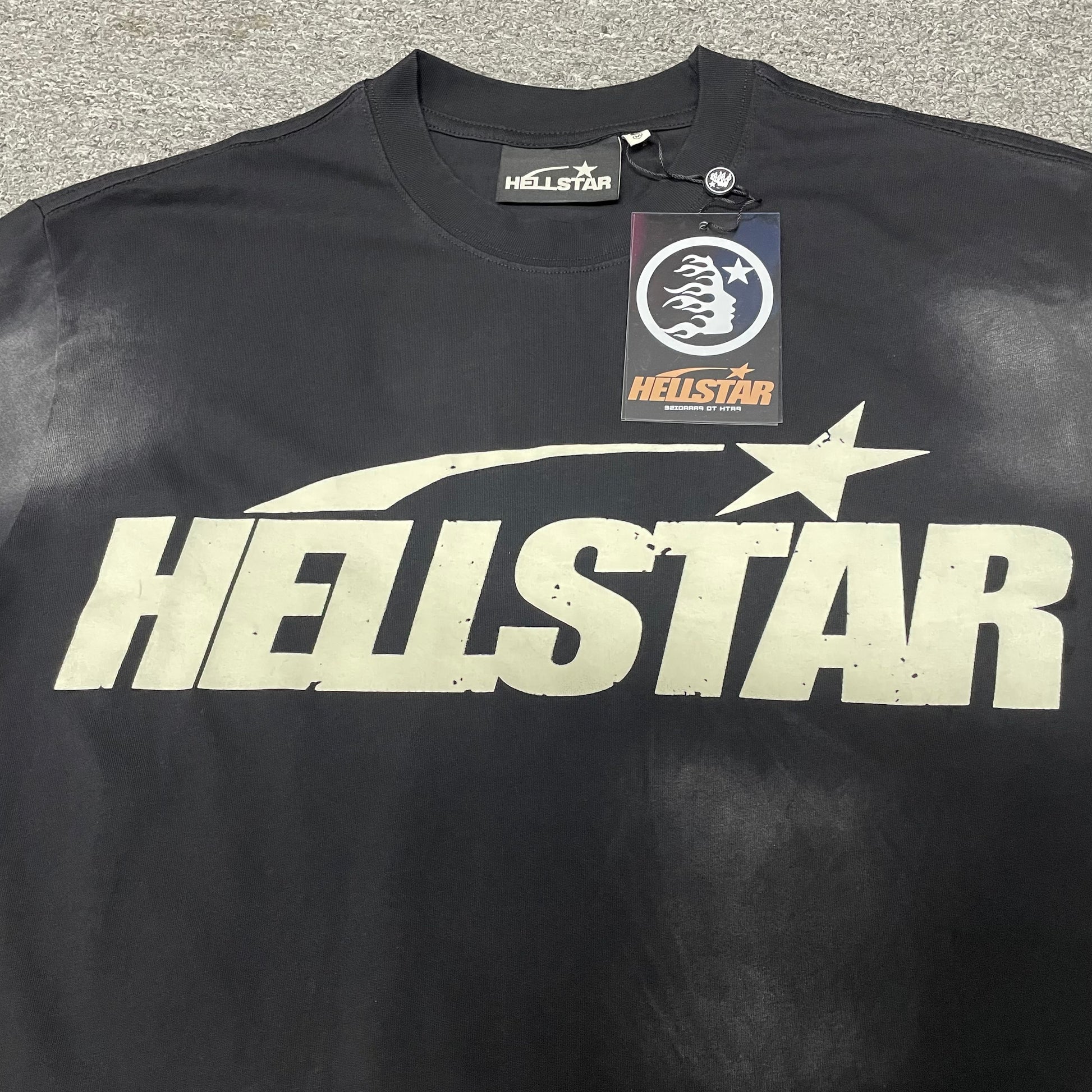 Full cream Hellstar Classic logo graphic on washed black T-shirt
Close-up of the cream Hellstar Classic logo on black T-shirt
Detailed cream logo print on Hellstar Classic washed black T-shirt
Oversized Hellstar lettering across the Classic black T-shirt
Hellstar shooting-star graphic above the cream logo lettering