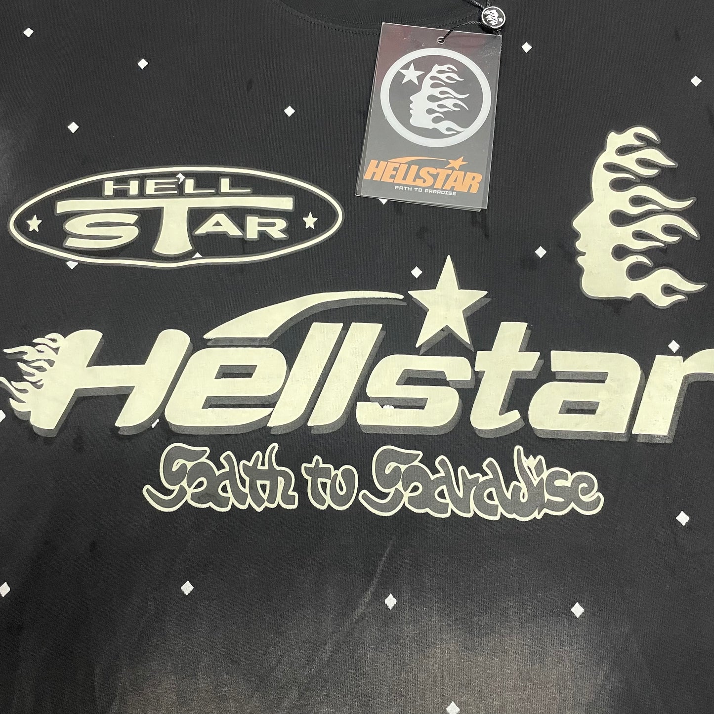 Full cream multi-logo graphic on Hellstar Death to Paradise black T-shirt
Close-up of the Death to Paradise front graphic on Hellstar black T-shirt
Detailed cream logo and flame artwork on Hellstar Death to Paradise T-shirt
Large cream Hellstar logo across the Death to Paradise black T-shirt
Death to Paradise lettering below the Hellstar logo on black T-shirt