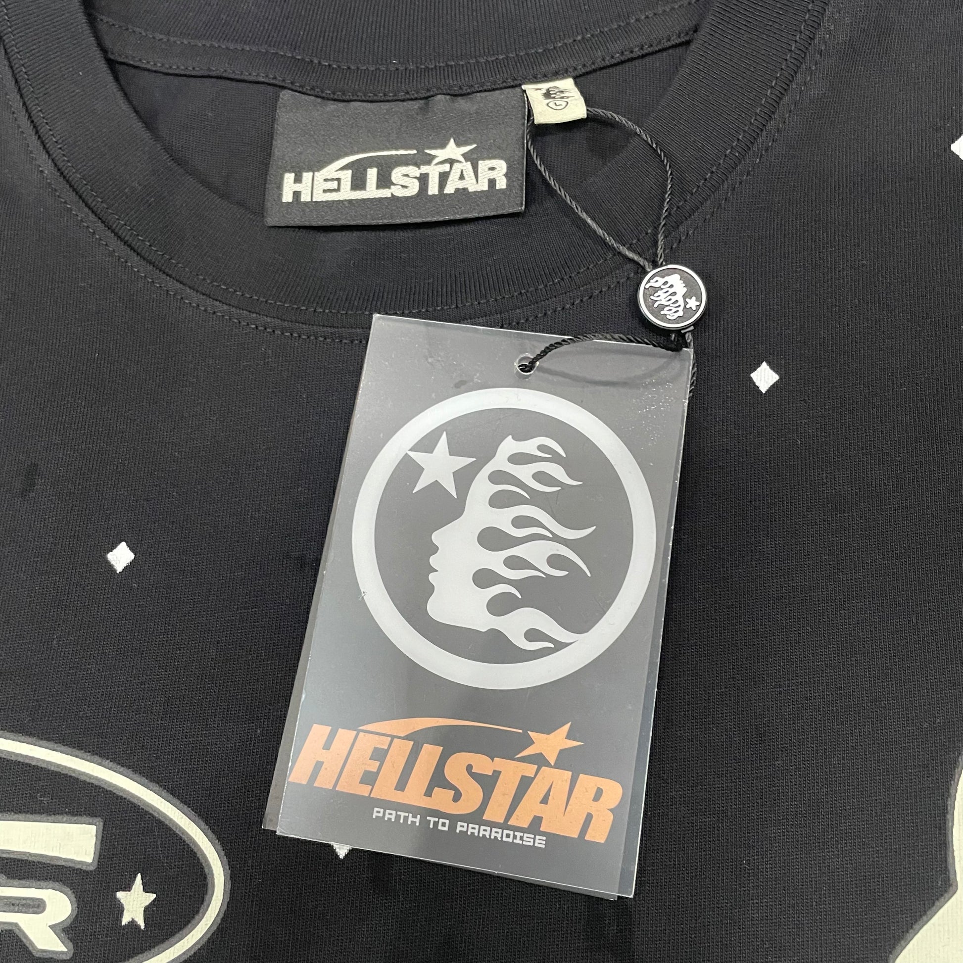 Crew neck collar and stitching detail on Hellstar Death to Paradise T-shirt
Hellstar woven neck label inside Death to Paradise washed black T-shirt
Hellstar size label detail inside Death to Paradise black T-shirt
Hellstar branded hangtag attached to Death to Paradise black T-shirt