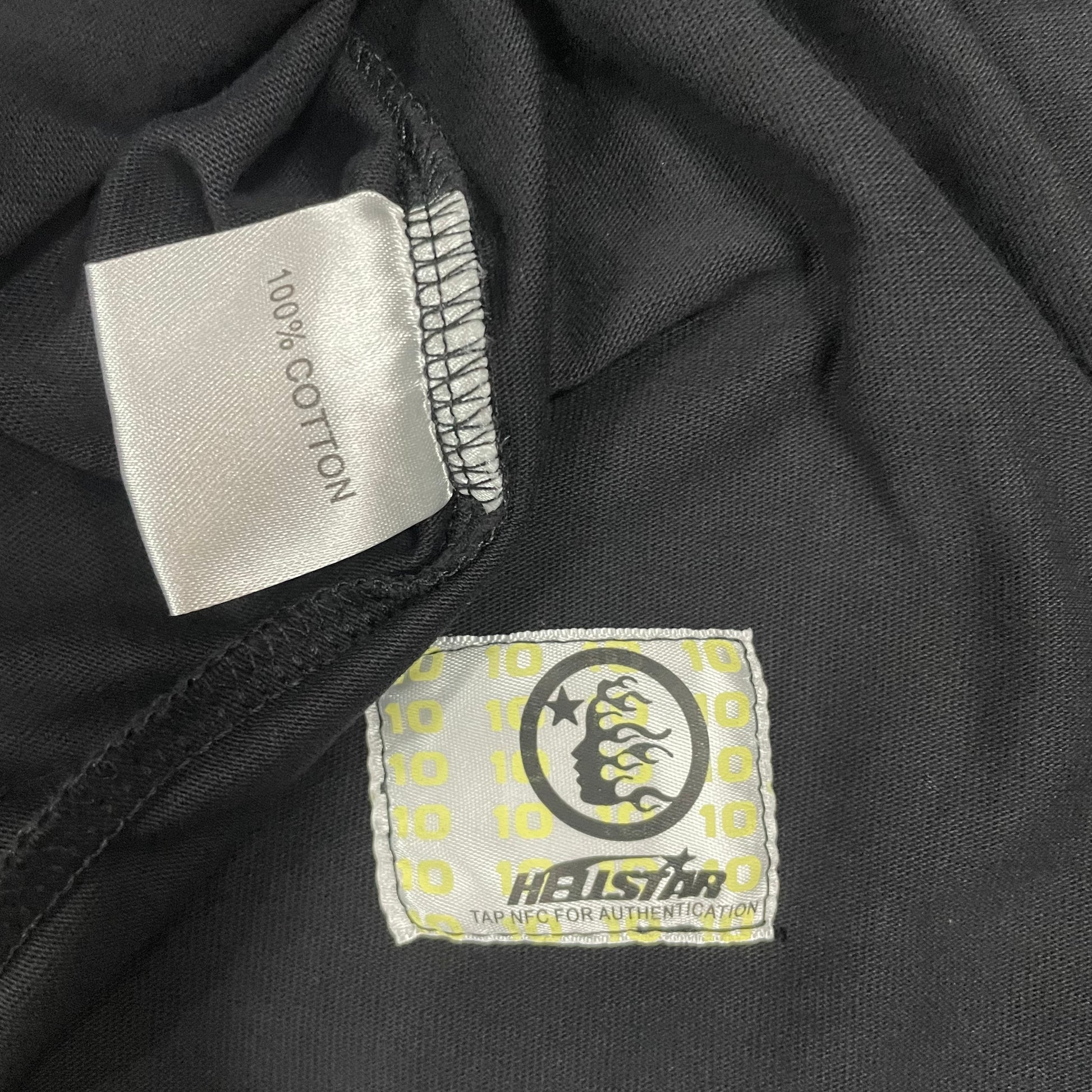 Hellstar wash care label inside Death to Paradise graphic T-shirt
NFC tag detail attached to Hellstar Death to Paradise T-shirt