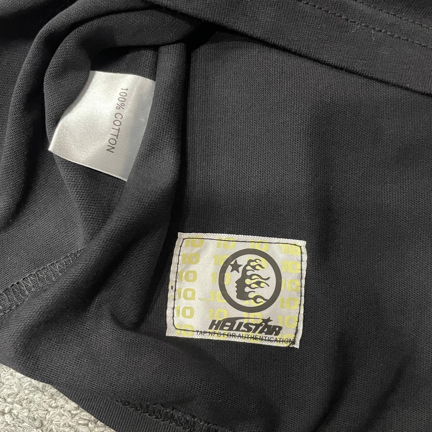 Hellstar wash care label inside Path to Paradise graphic T-shirt
NFC tag detail attached to Hellstar Path to Paradise T-shirt