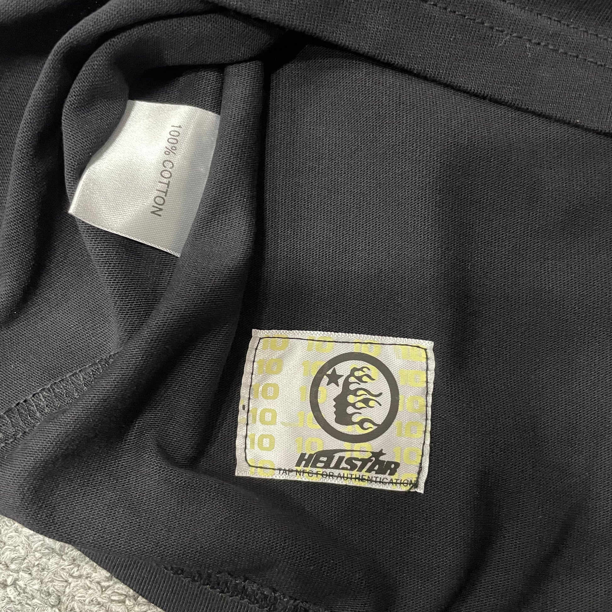 Hellstar wash care label inside Path to Paradise graphic T-shirt
NFC tag detail attached to Hellstar Path to Paradise T-shirt