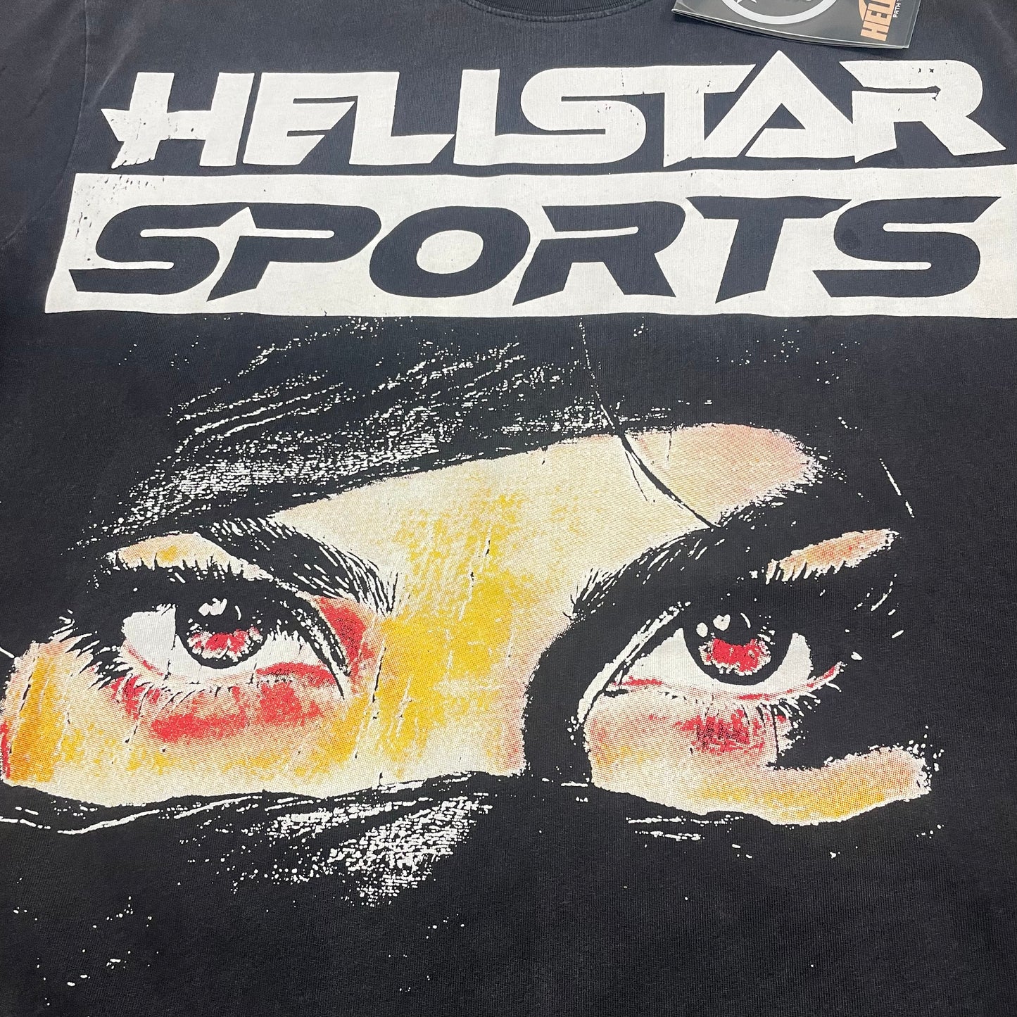 Full Hellstar Sports eye graphic on Blur washed black T-shirt
Detailed cream red and black artwork on Hellstar Blur graphic T-shirt
Close-up eye artwork with black face covering on Hellstar Blur T-shirt
Black face covering graphic detail on Hellstar Blur T-shirt
Oversized Hellstar Sports logo above the eye graphic on black T-shirt