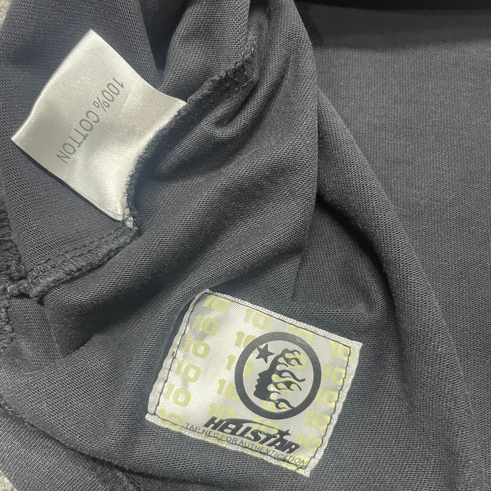 Hellstar wash care label inside Blur graphic T-shirt
NFC tag detail attached to Hellstar Blur washed black T-shirt