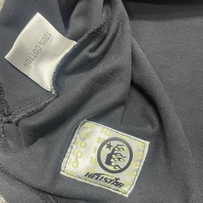 Hellstar wash care label inside Blur graphic T-shirt
NFC tag detail attached to Hellstar Blur washed black T-shirt