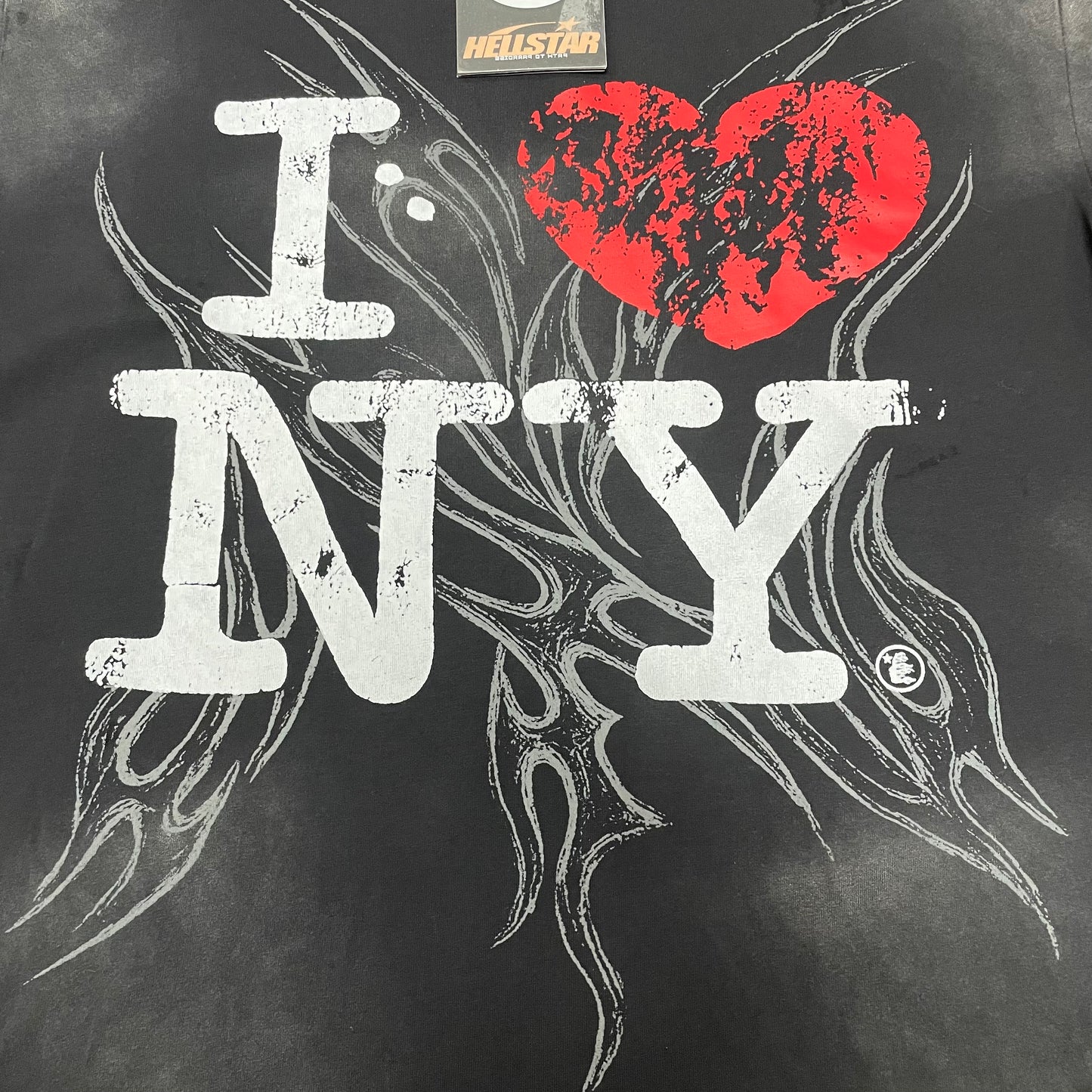 Full I Love NY red heart graphic on Hellstar washed black T-shirt
Detailed white red and black artwork on Hellstar I Love NY T-shirt
Oversized white I Love NY lettering and red heart on Hellstar T-shirt
Large distressed red heart graphic on Hellstar I Love NY T-shirt
Dark tribal-style artwork behind the I Love NY graphic on Hellstar T-shirt