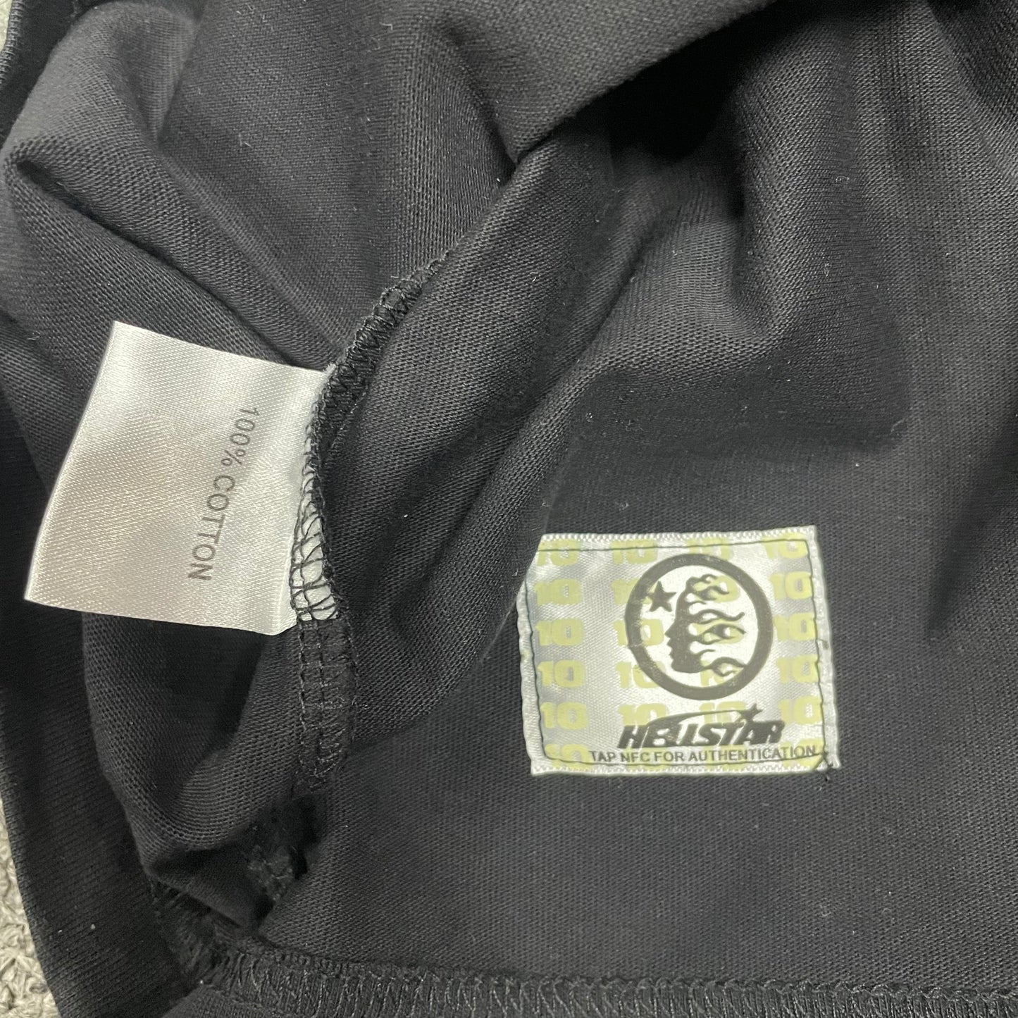 Care and fabric label inside Hellstar washed black T-shirt
NFC tag detail on Hellstar washed black rhinestone T-shirt