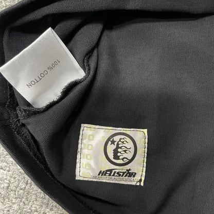 Fabric composition and care label inside Hellstar washed black T-shirt
NFC tag detail on Hellstar rhinestone distressed black T-shirt