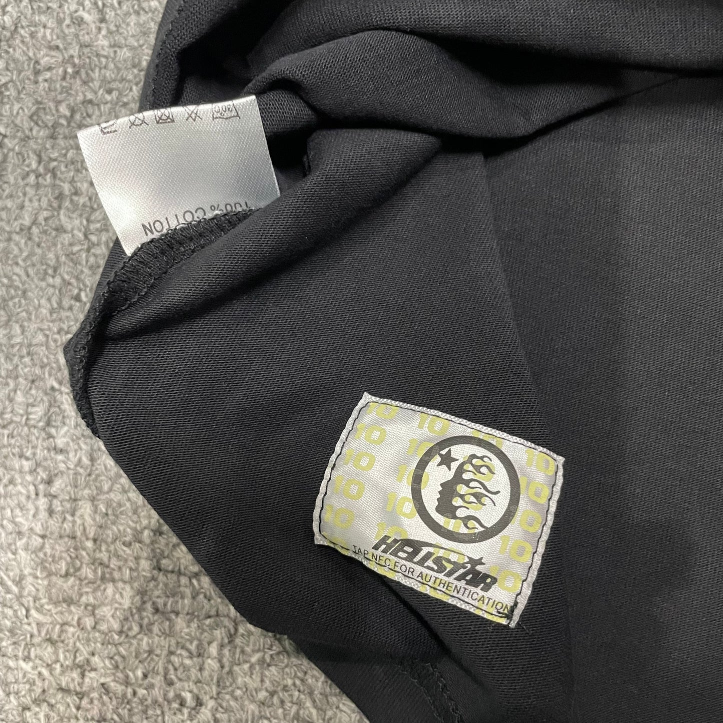 Fabric composition and care label inside Hellstar Flame Face T-shirt
NFC tag detail on Hellstar Flame Face washed black T-shirt