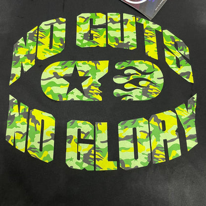 Oversized green camo No Guts No Glory graphic on Hellstar black T-shirt
Hellstar No Guts No Glory circular logo with green camouflage pattern
Close-up of green camo No Guts No Glory graphic print
Detailed view of Hellstar flame face and camouflage print texture