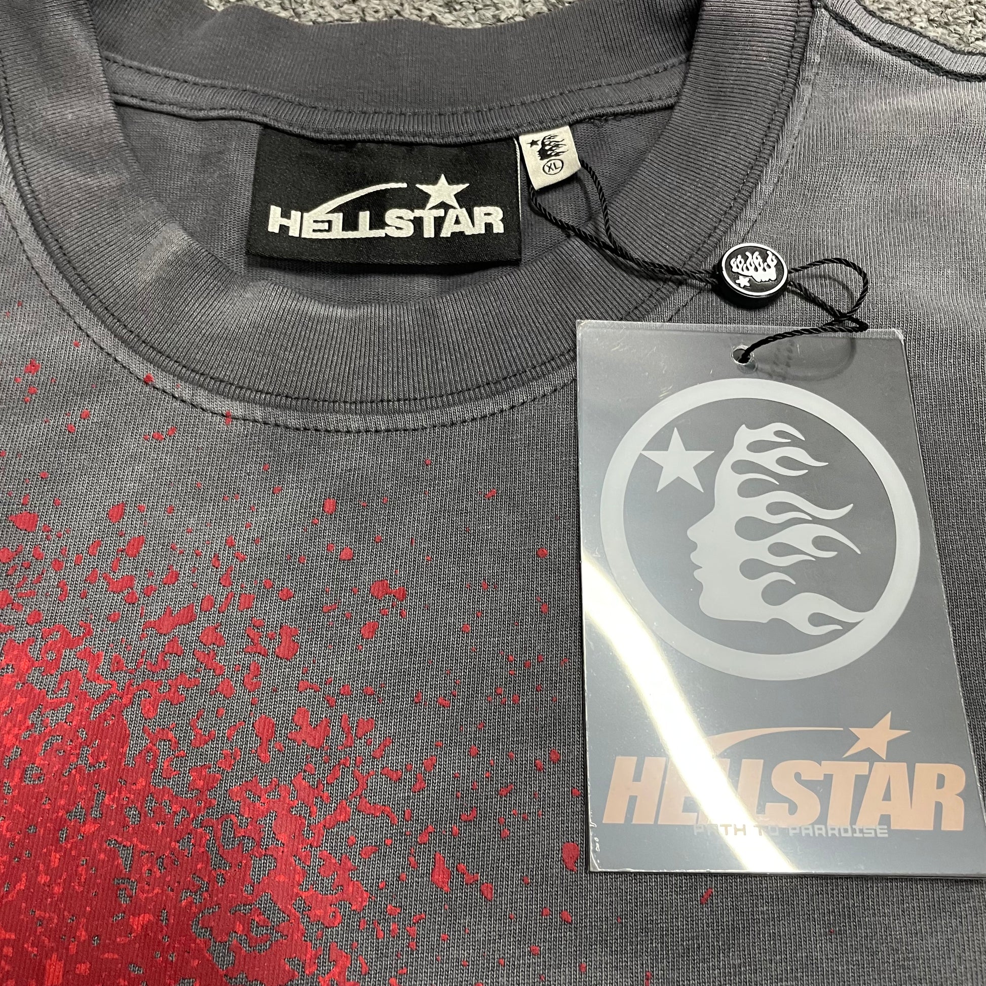 Close-up of ribbed crew neck and reinforced neckline stitching on Hellstar T-shirt
Hellstar branded neck label inside Spray Paint Logo T-shirt
Size label inside Hellstar Spray Paint Logo washed grey T-shirt
Hellstar branded hang tag attached to Spray Paint Logo T-shirt