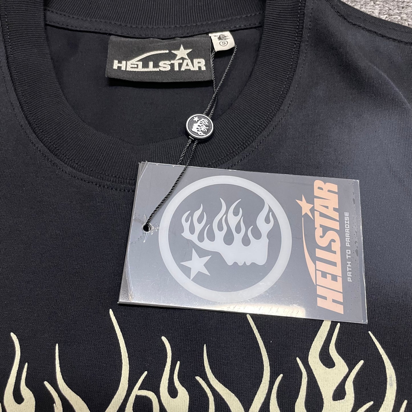 Close-up of ribbed crew neck and reinforced neckline stitching on Hellstar T-shirt
Hellstar branded neck label inside Records graphic T-shirt
Size label inside Hellstar Records T-shirt
Hellstar branded hang tag attached to Records graphic T-shirt
